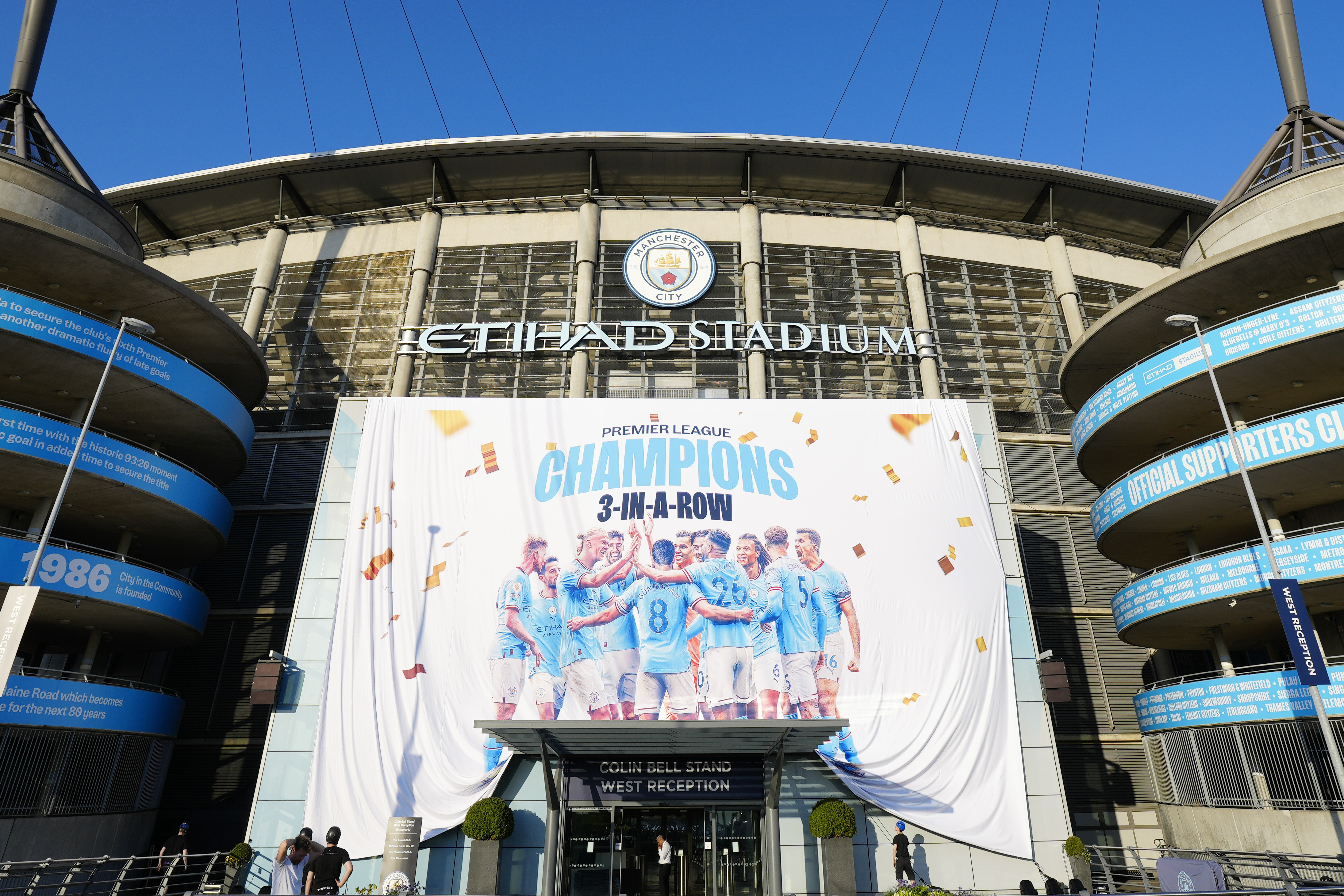 A banner celebrating their title win is unfurled outside Manchester City's Etihad stadium in Manchester, England, Saturday, May 20, 2023. Manchester City clinched the English Premier League title on Saturday after their nearest challengers Arsenal lost 1-0 to Nottingham Forest. 