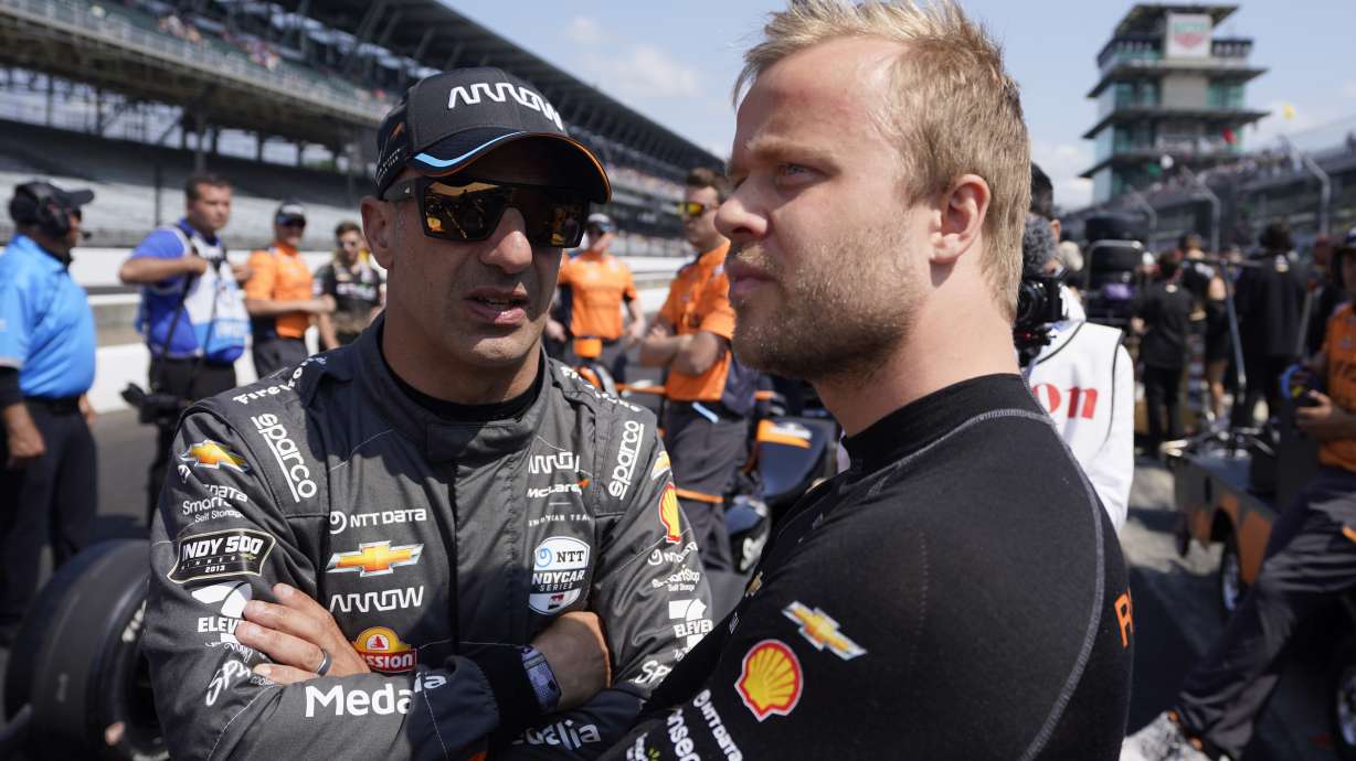 Tony Kanaan, left, of Brazil, talks with Felix Rosenqvist, of Sweden, during qualifications for the Indianapolis 500 auto race at Indianapolis Motor Speedway, Saturday, May 20, 2023, in Indianapolis.