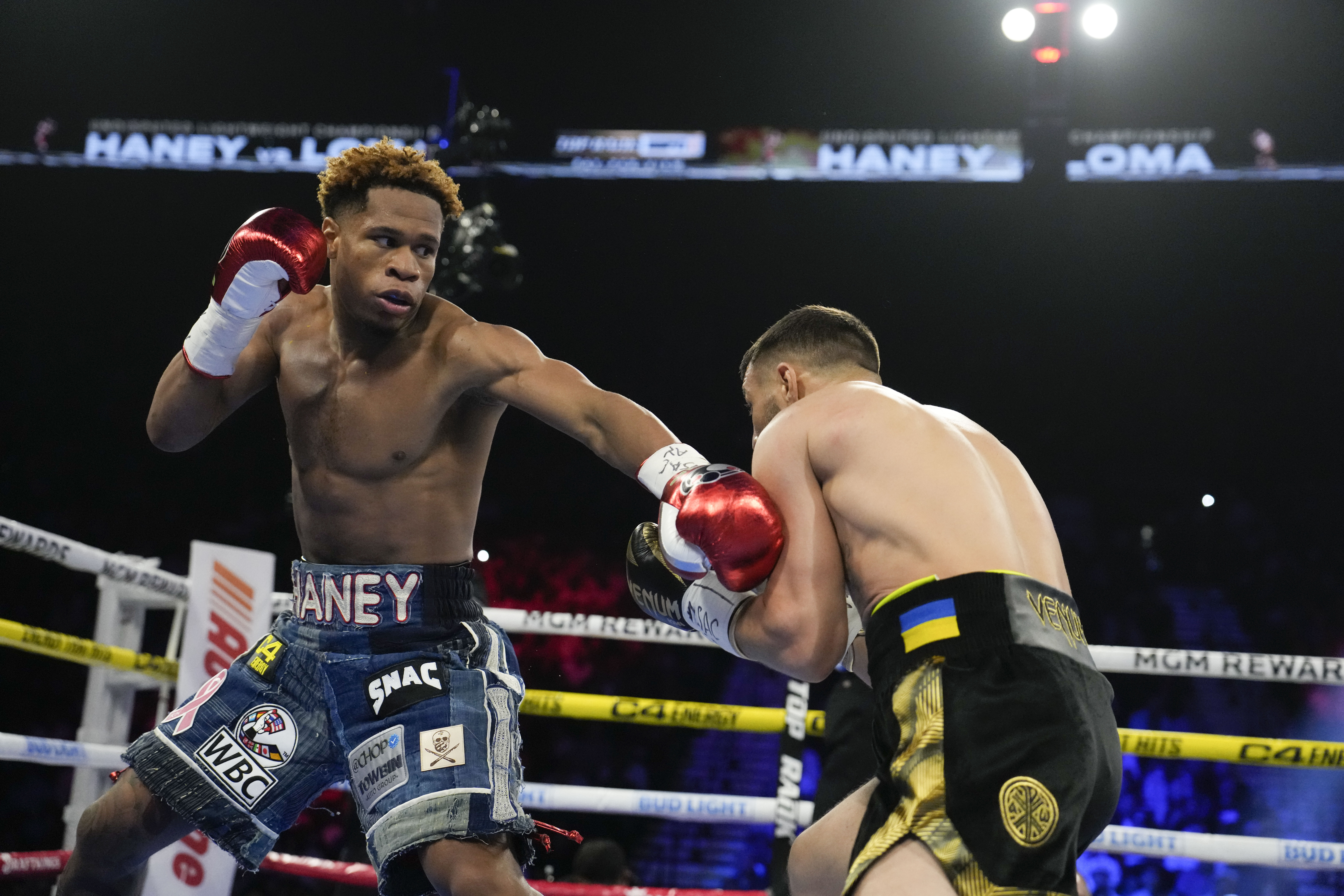Devin Haney, left, fights Vasiliy Lomachenko in an undisputed lightweight championship boxing match Saturday, May 20, 2023, in Las Vegas. 