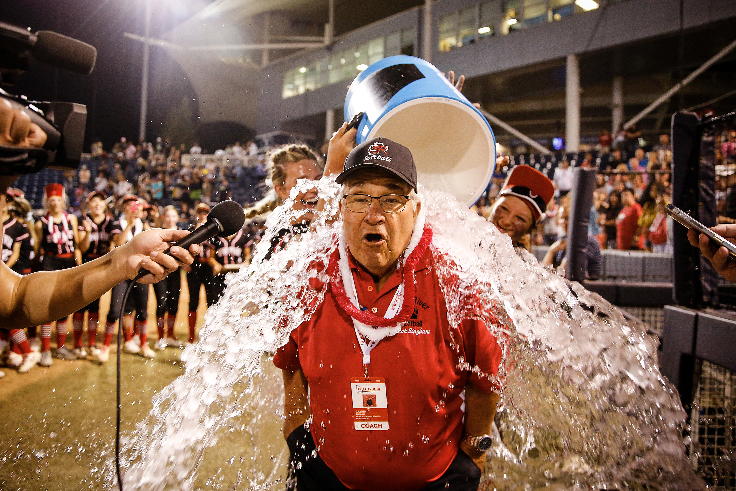 Bear River Head Coach Calvin Bingham gets doused after winning his 11th and final state championship at Gail Miller Field in Provo, Utah on Saturday, May 20, 2023.