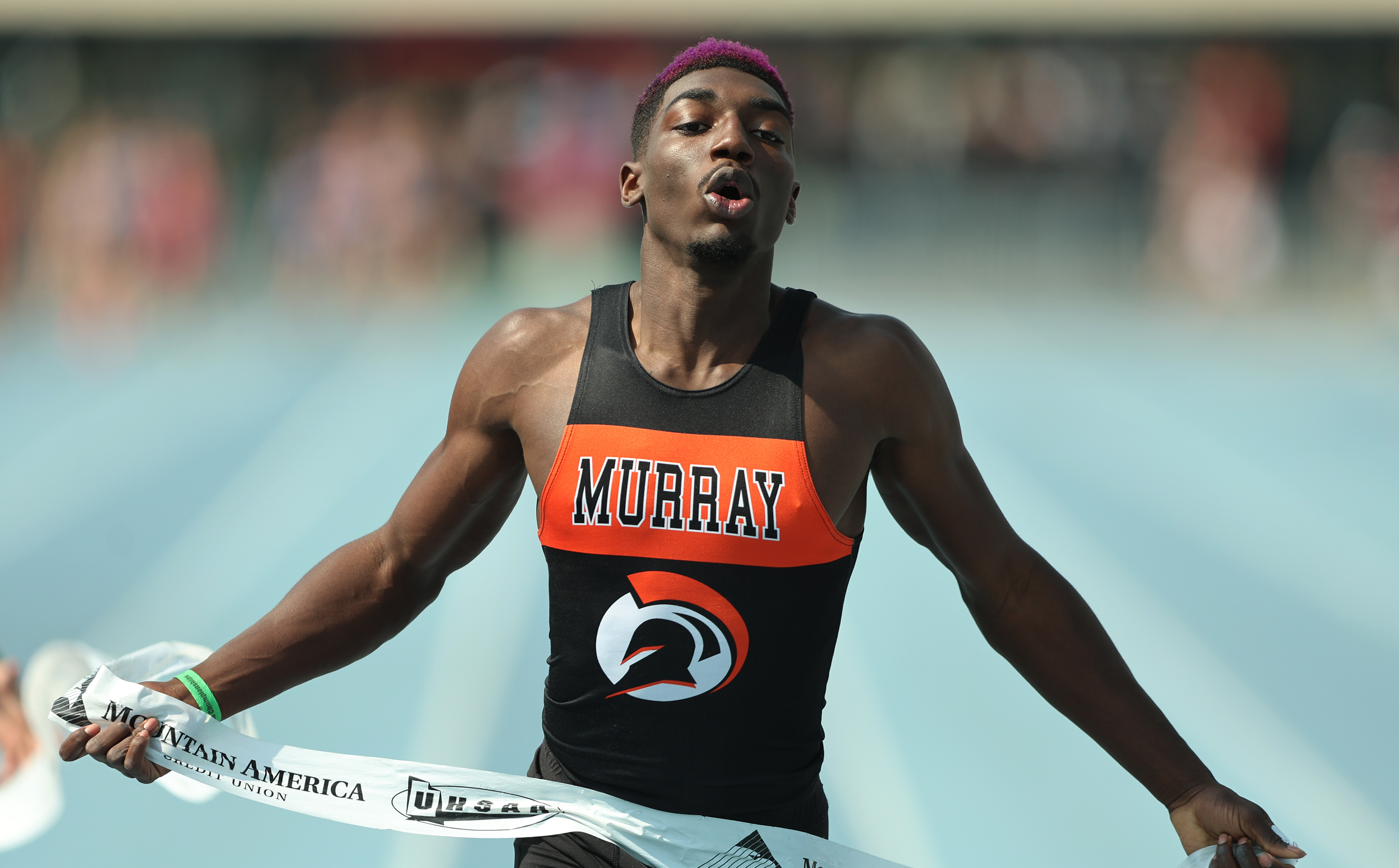 Weber State commit Amari Adams of Murray leans into the tape to win the state 100-meter title in 10.53 during the UHSAA 5A state track and field meet at BYU, Saturday, May 20, 2023.