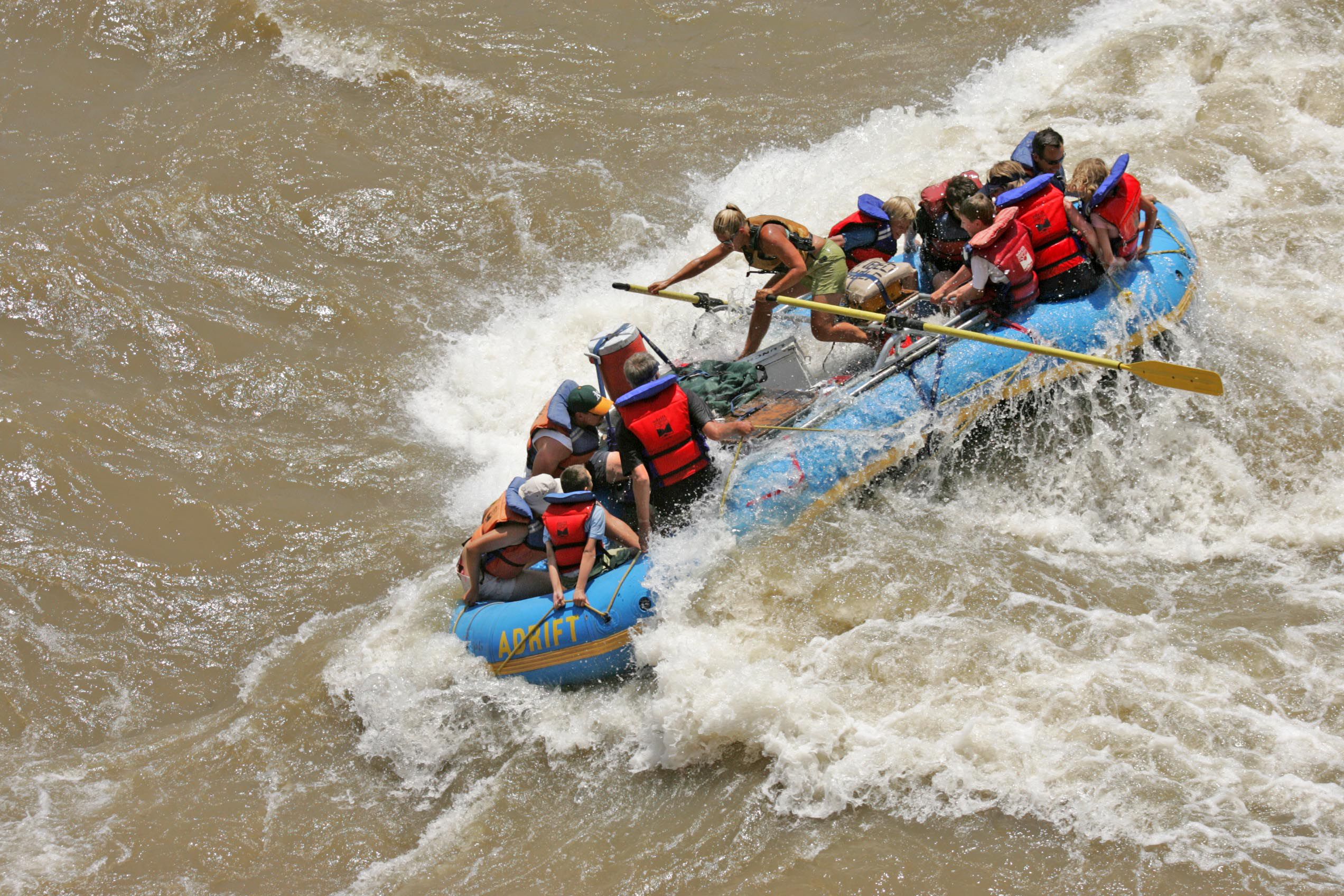 A river guide pilots an Adrift Adventures boat through the Colorado River rapids in July 10, 2008. Record high flows are expected this year.