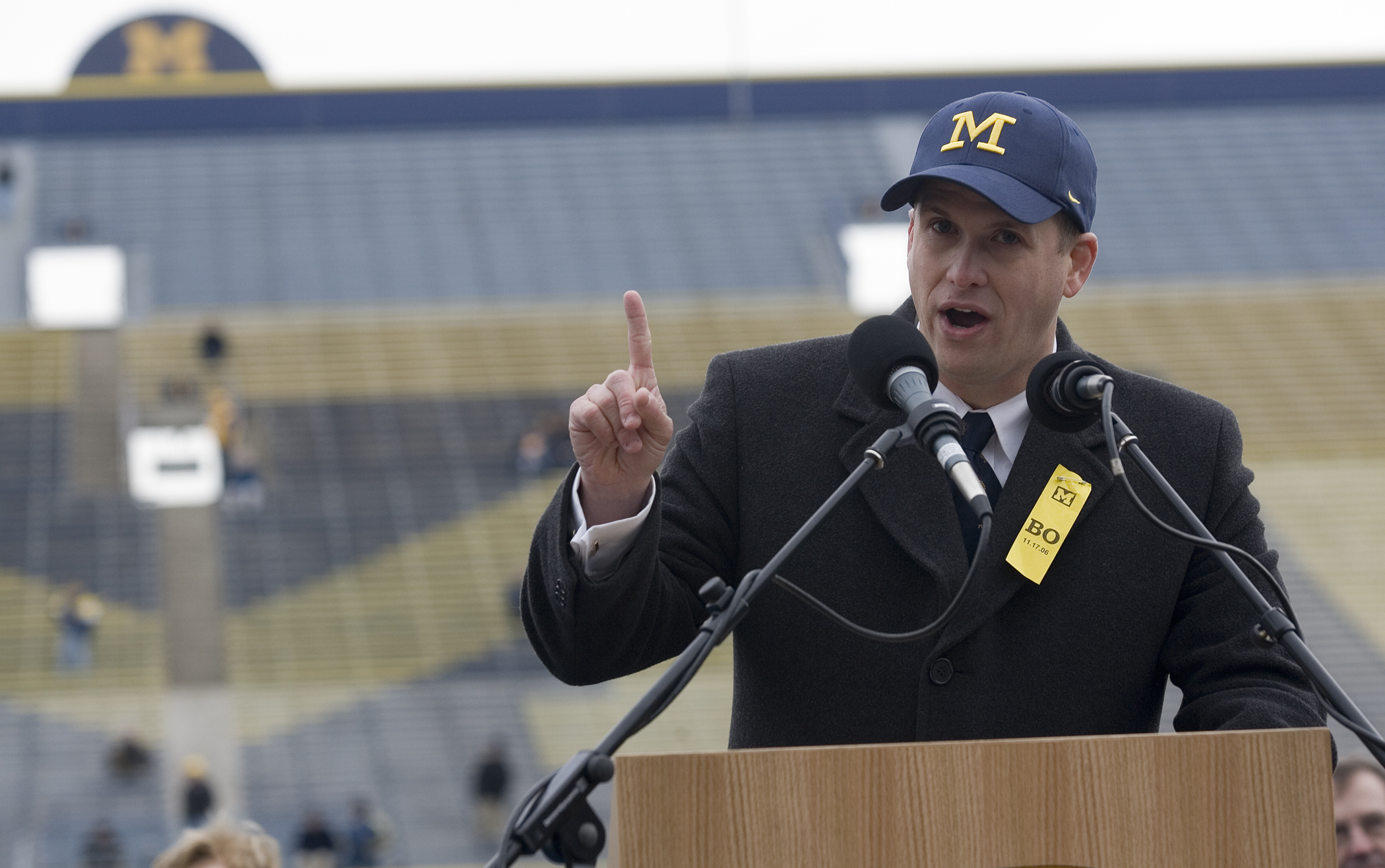 FILE - Glenn "Shemy" Schembechler III, son of former Michigan football coach Bo Schembechler, speaks at a public memorial service for his father, Nov. 21, 2006, at Michigan Stadium in Ann Arbor, Mich. Schembechler has resigned from his position with the Wolverines, with the school saying it was aware of his social media activity that may have caused “pain” in the community. 