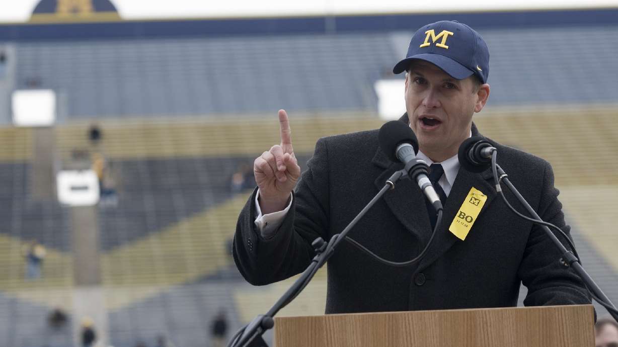 FILE - Glenn "Shemy" Schembechler III, son of former Michigan football coach Bo Schembechler, speaks at a public memorial service for his father, Nov. 21, 2006, at Michigan Stadium in Ann Arbor, Mich. Schembechler has resigned from his position with the Wolverines, with the school saying it was aware of his social media activity that may have caused “pain” in the community.