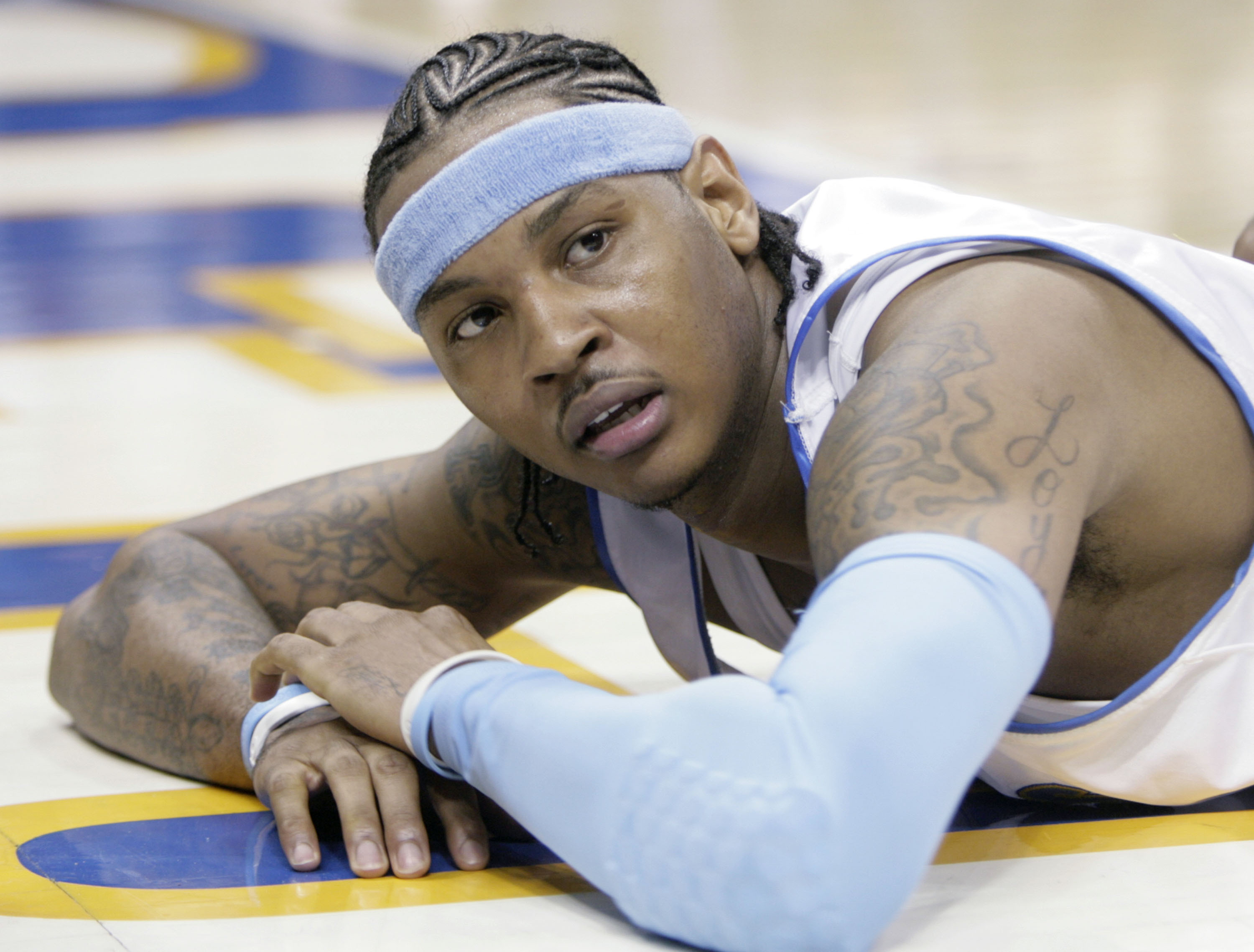 FILE - Denver Nuggets forward Carmelo Anthony looks up from the floor after getting called for a foul in the fourth quarter of game 3 of the NBA Western Conference playoff series against the San Antonio Spurs in Denver on April 28, 2007. Anthony, the star forward who led Syracuse to an NCAA championship in his lone college season and went on to spend 19 years in the NBA, announced his retirement on Monday, May 22, 2023. 