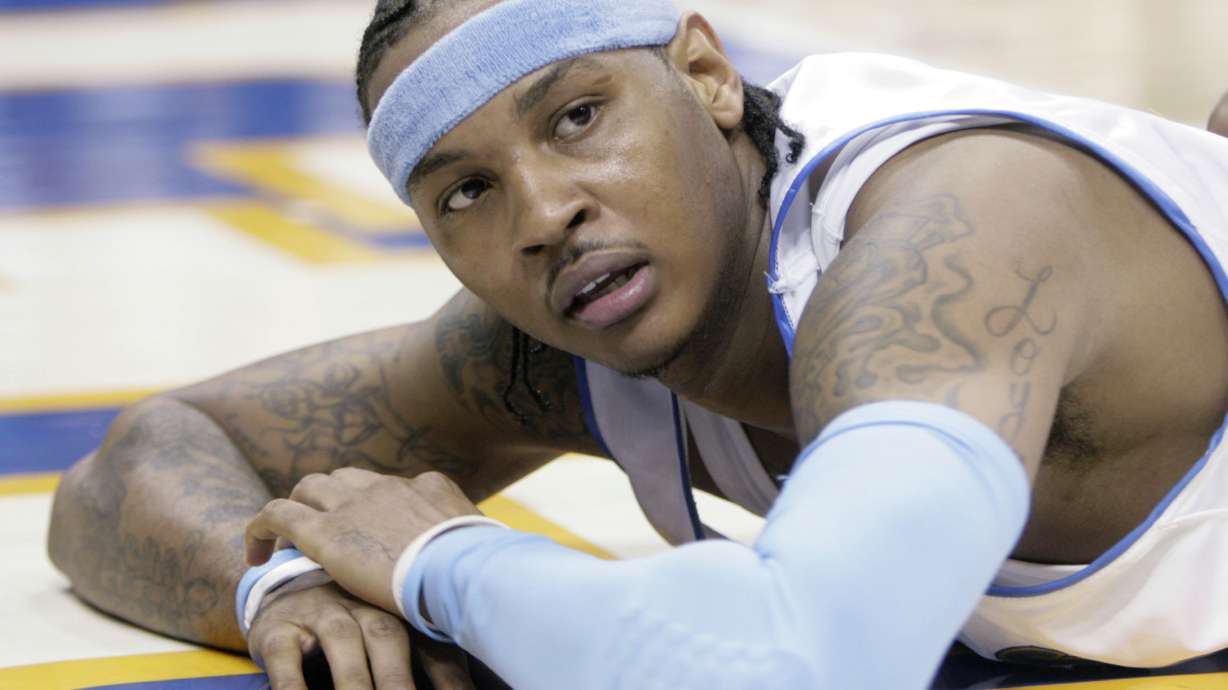 FILE - Denver Nuggets forward Carmelo Anthony looks up from the floor after getting called for a foul in the fourth quarter of game 3 of the NBA Western Conference playoff series against the San Antonio Spurs in Denver on April 28, 2007. Anthony, the star forward who led Syracuse to an NCAA championship in his lone college season and went on to spend 19 years in the NBA, announced his retirement on Monday, May 22, 2023.