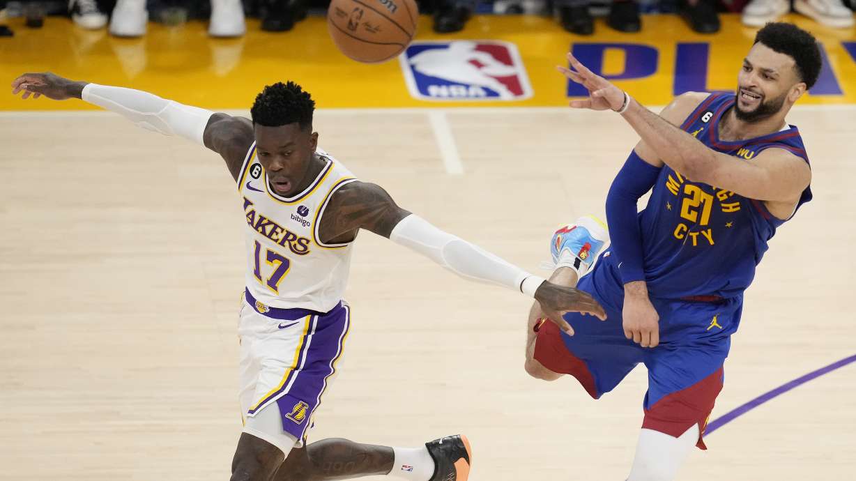 Denver Nuggets guard Jamal Murray, right, passes over Los Angeles Lakers guard Dennis Schroder (17) in the second half of Game 3 of the NBA basketball Western Conference Final series Saturday, May 20, 2023, in Los Angeles.