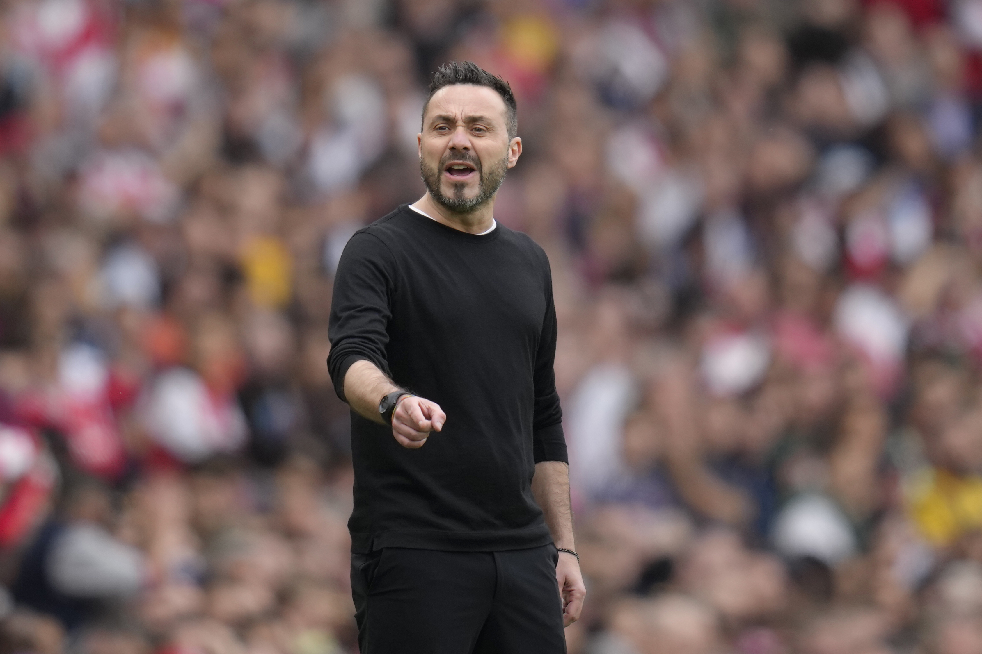 Brighton's head coach Roberto De Zerbi gives instructions during the English Premier League soccer match between Arsenal and Brighton and Hove Albion at Emirates stadium in London, Sunday, May 14, 2023.