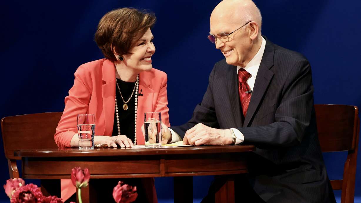 Sister Kristen Oaks, smiles over at her husband President Dallin H. Oaks as they speak to young adults of the church during a Worldwide Devotional from the Conference Center Theater in Salt Lake City on Sunday.