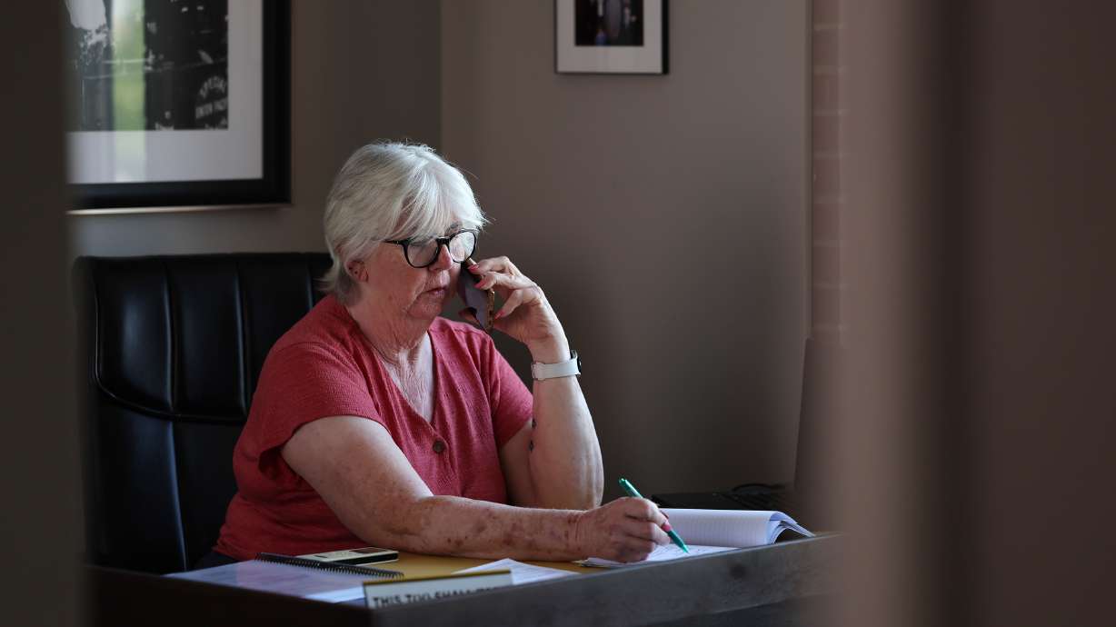 Diane Lewis, chairwoman of the Utah Democratic Party, talks on her phone inside her office at the party headquarters in Salt Lake City on July 26, 2022. Lewis was reelected as her party's chairwoman on Saturday.