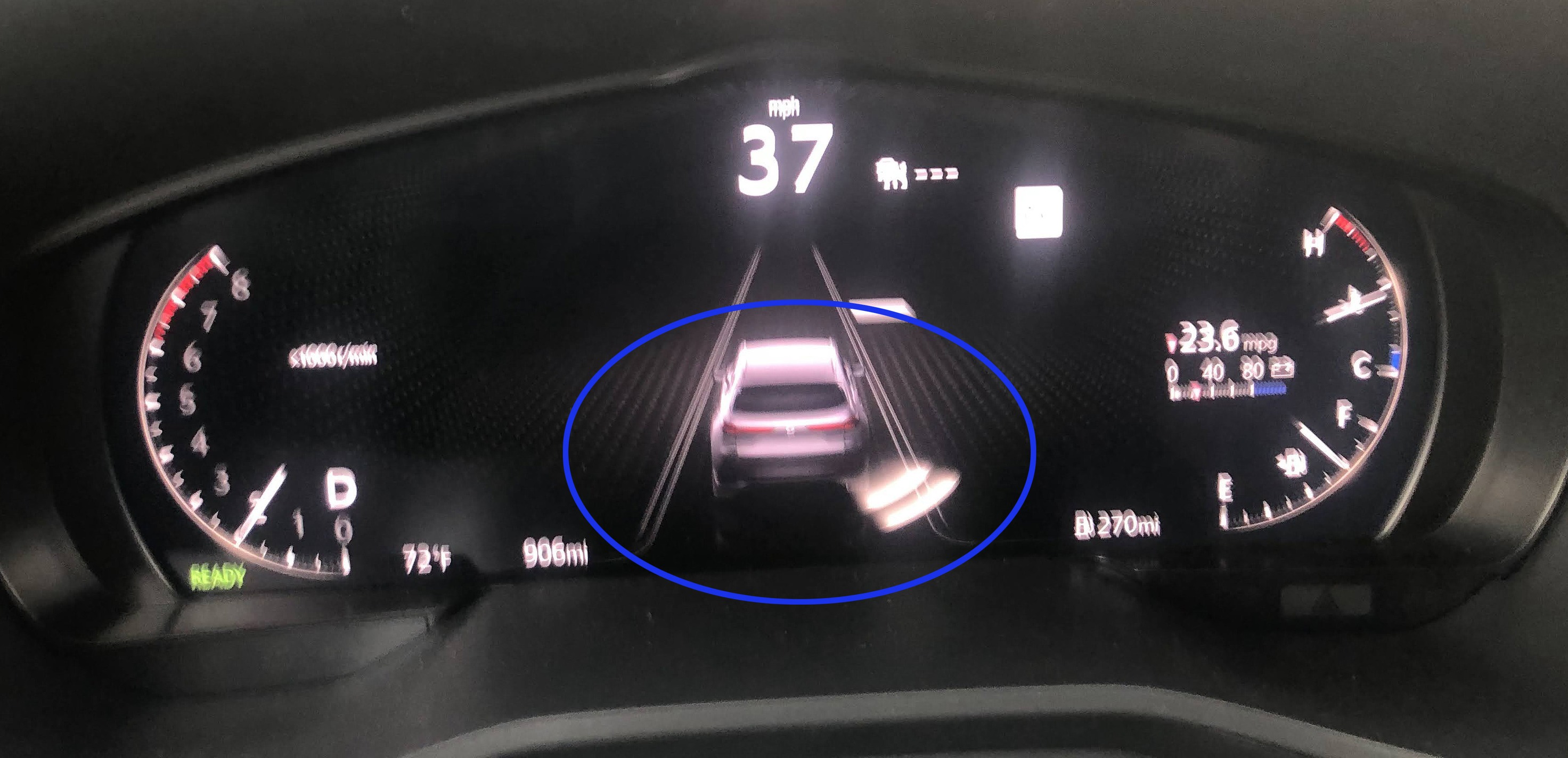 The blue circle highlights how the blindspot warning appears on the dash.