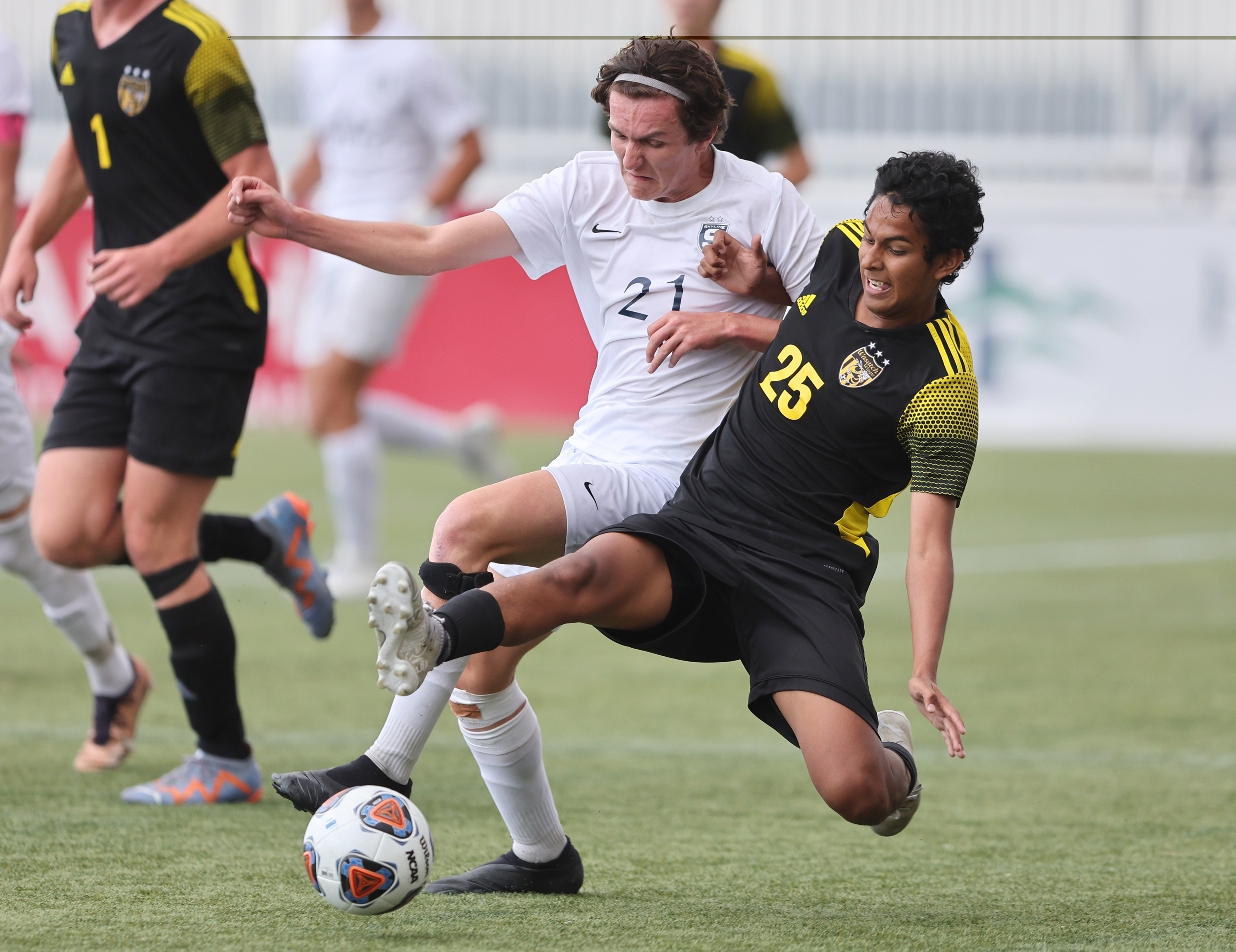 Skyline’s Dante Stock (21) and Wasatch’s Gilberto Vargas (25) battle for control of the ball as they play in 5A boys soccer state semifinal action at Zions Bank Stadium in Herriman on Monday, May 22, 2023. Wasatch won 1-0.
