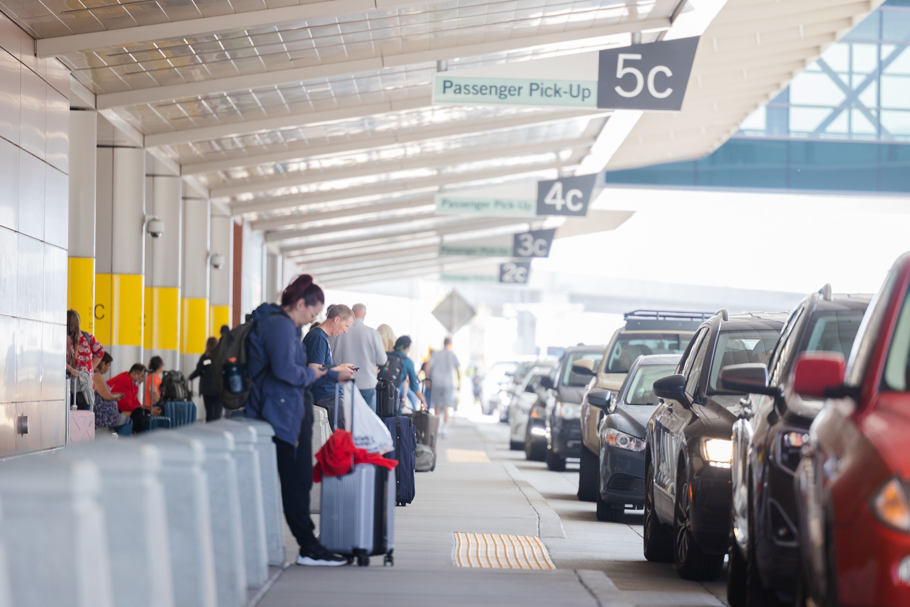 Travelers wait to be picked up at the Salt Lake City International Airport in Salt Lake City on May 19.