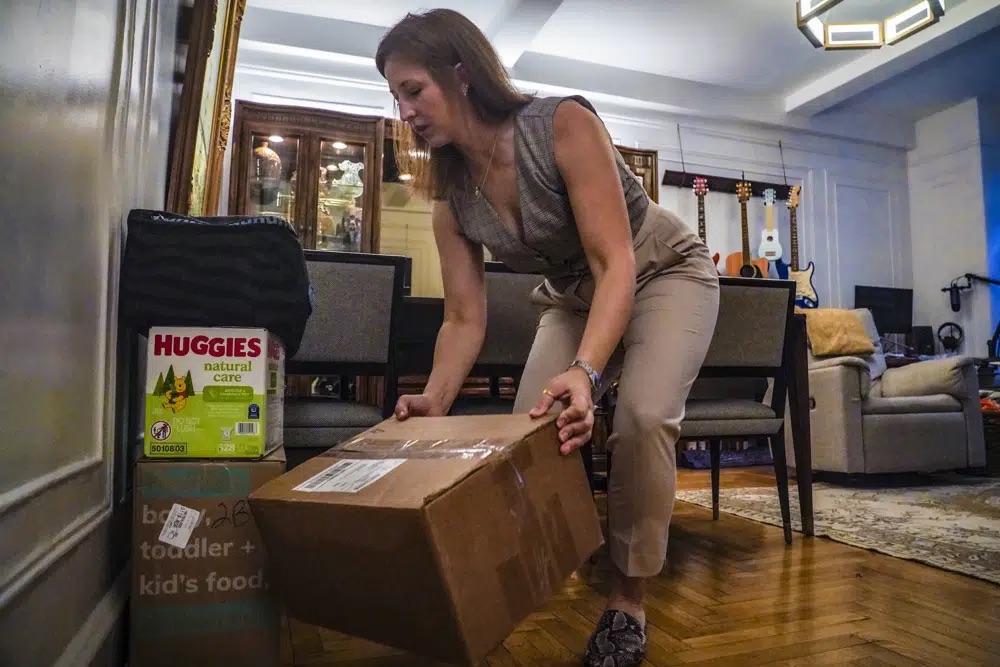 Jessica Ray moves deliveries from UPS, including baby food and diapers for her child, in her apartment on Friday in New York. Ray, who relies on delivery for virtually everything, said she is concerned about delays in deliveries should UPS workers strike.