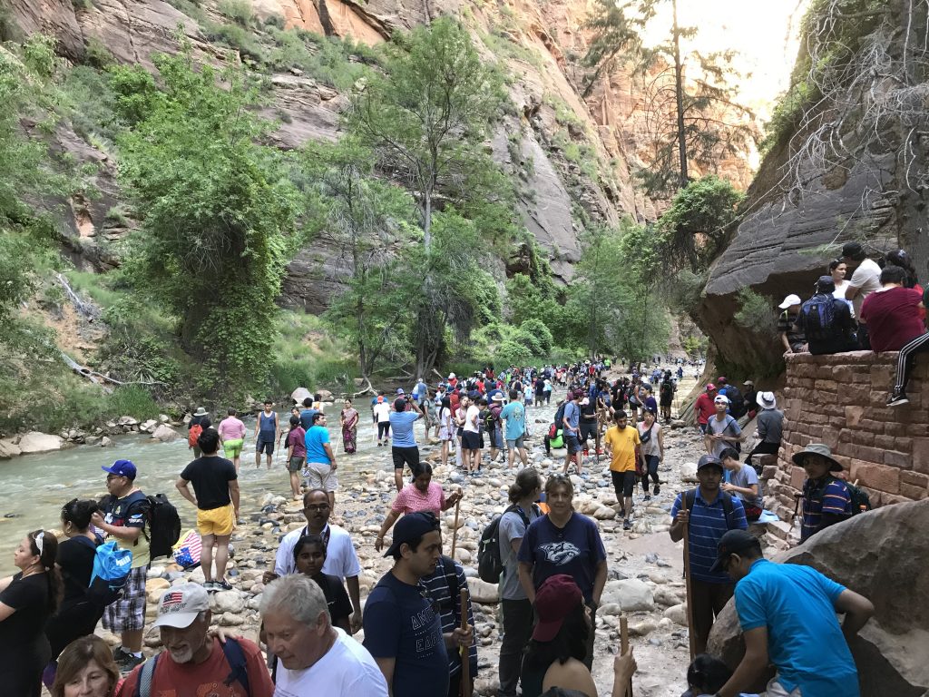 Crowds gather at the entrance to the Narrows, Zion National Park, Utah, date not specified. Officials are encouraging visitors to take in the sights at lesser-known parks this summer.