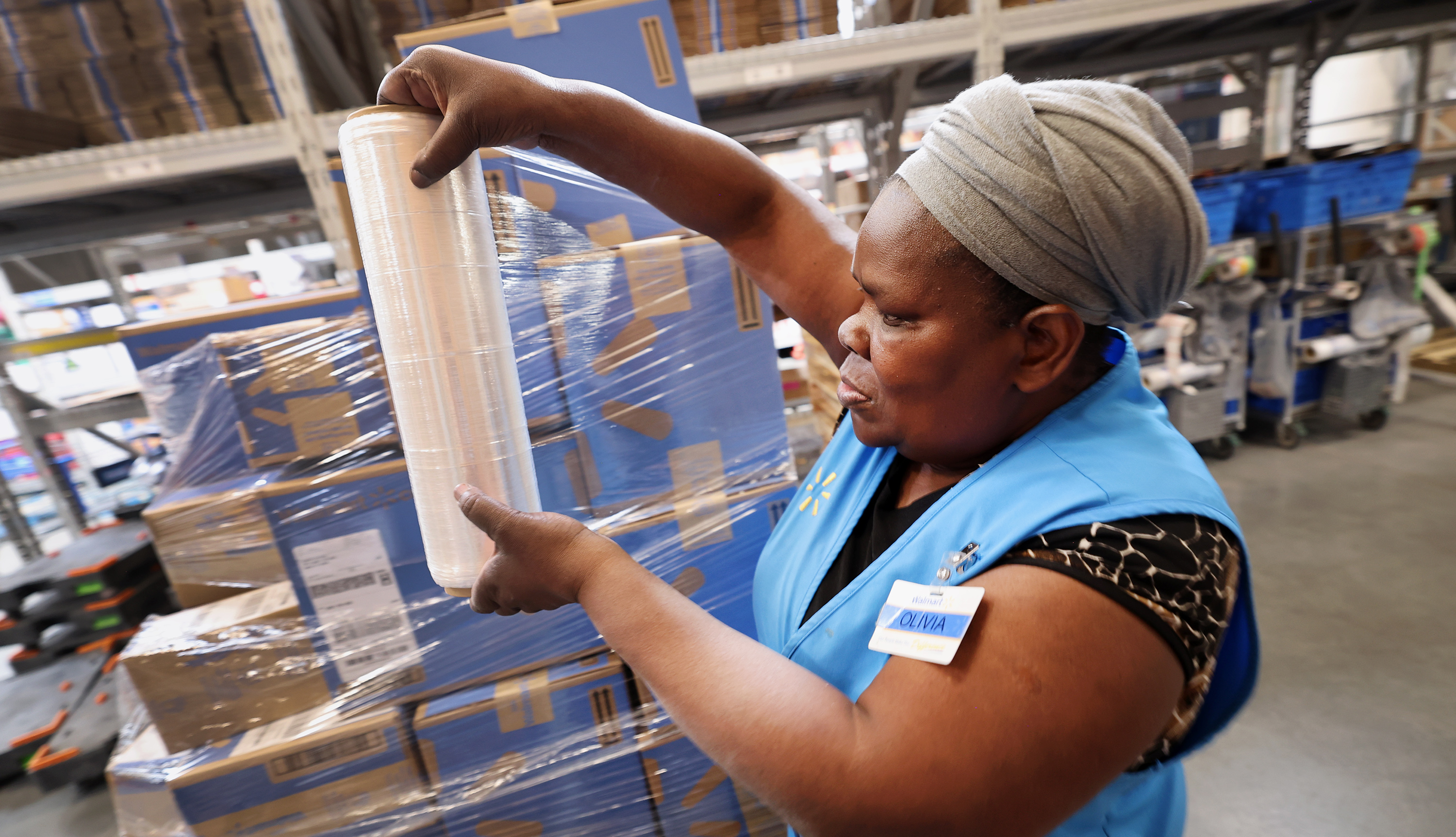 Olivia Sserabira, from Uganda, works at Walmart in Salt Lake City shipping packages out to customers on May 19.