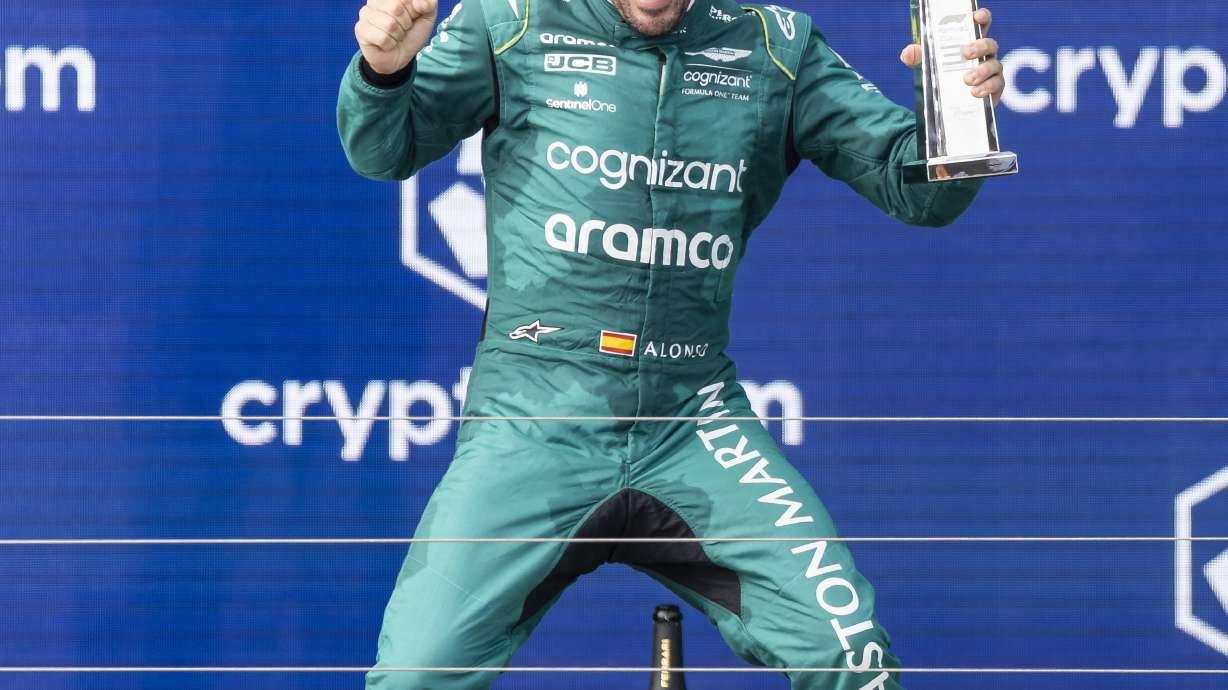 Spanish Formula One driver Fernando Alonso of Aston Martin holds the trophy and reacts after placing third at the Formula One Miami Grand Prix at the Miami International Autodrome on Sunday, May 7, 2023, in Miami Gardens, Fla.