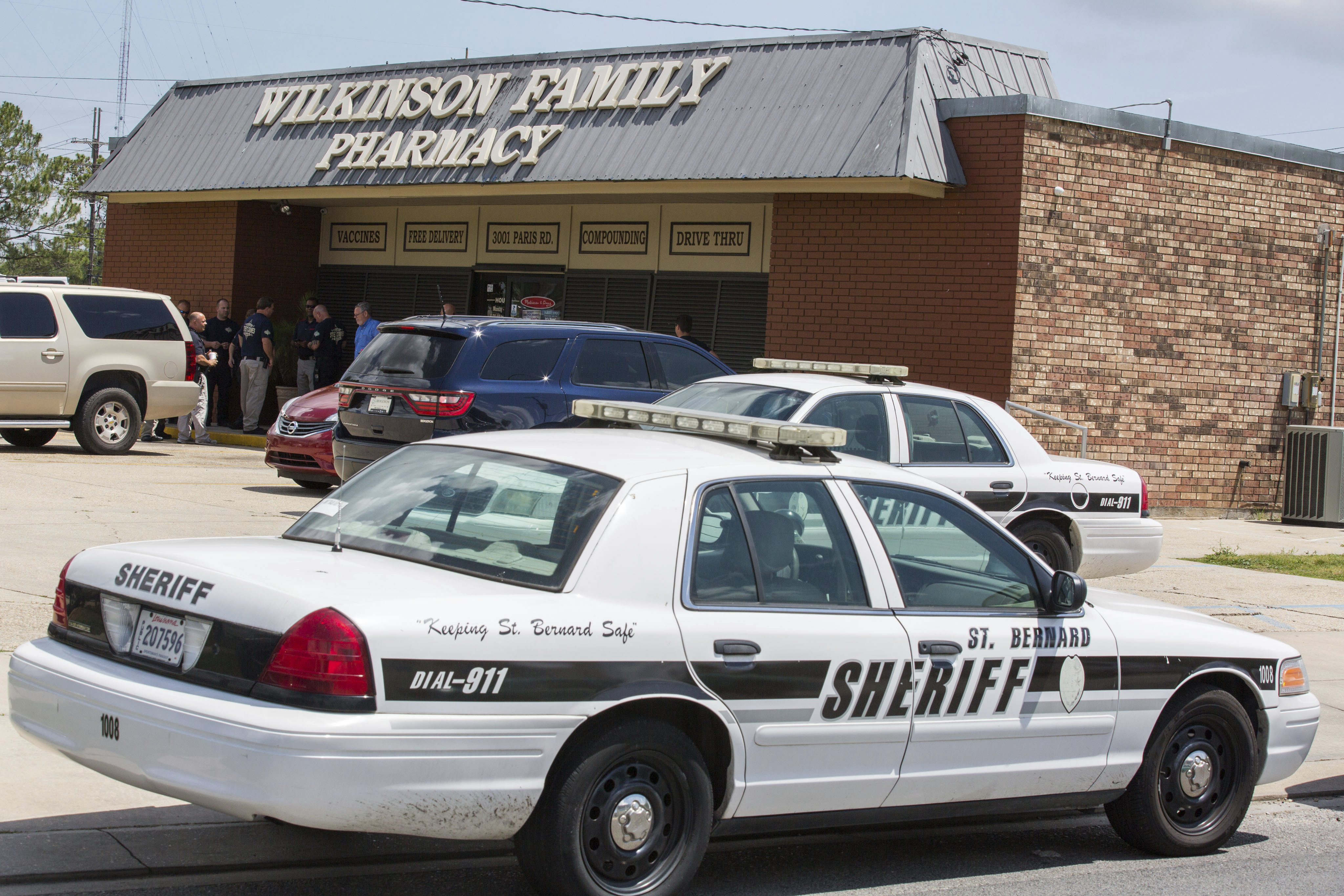 Accompanied by local law enforcement, U.S. Drug Enforcement Administration agents raid Wilkinson Family Pharmacy in Chalmette, La., April 19, 2017. Wilkinson purchased more than 4.5 million pills of oxycodone and hydrocodone from Morris & Dickson between 2014 and 2017, and federal prosecutors say during that time owner Keith Wilkinson laundered more than $345,000 from illegal opioid sales made with forged prescriptions or written by “pill mill” doctors.