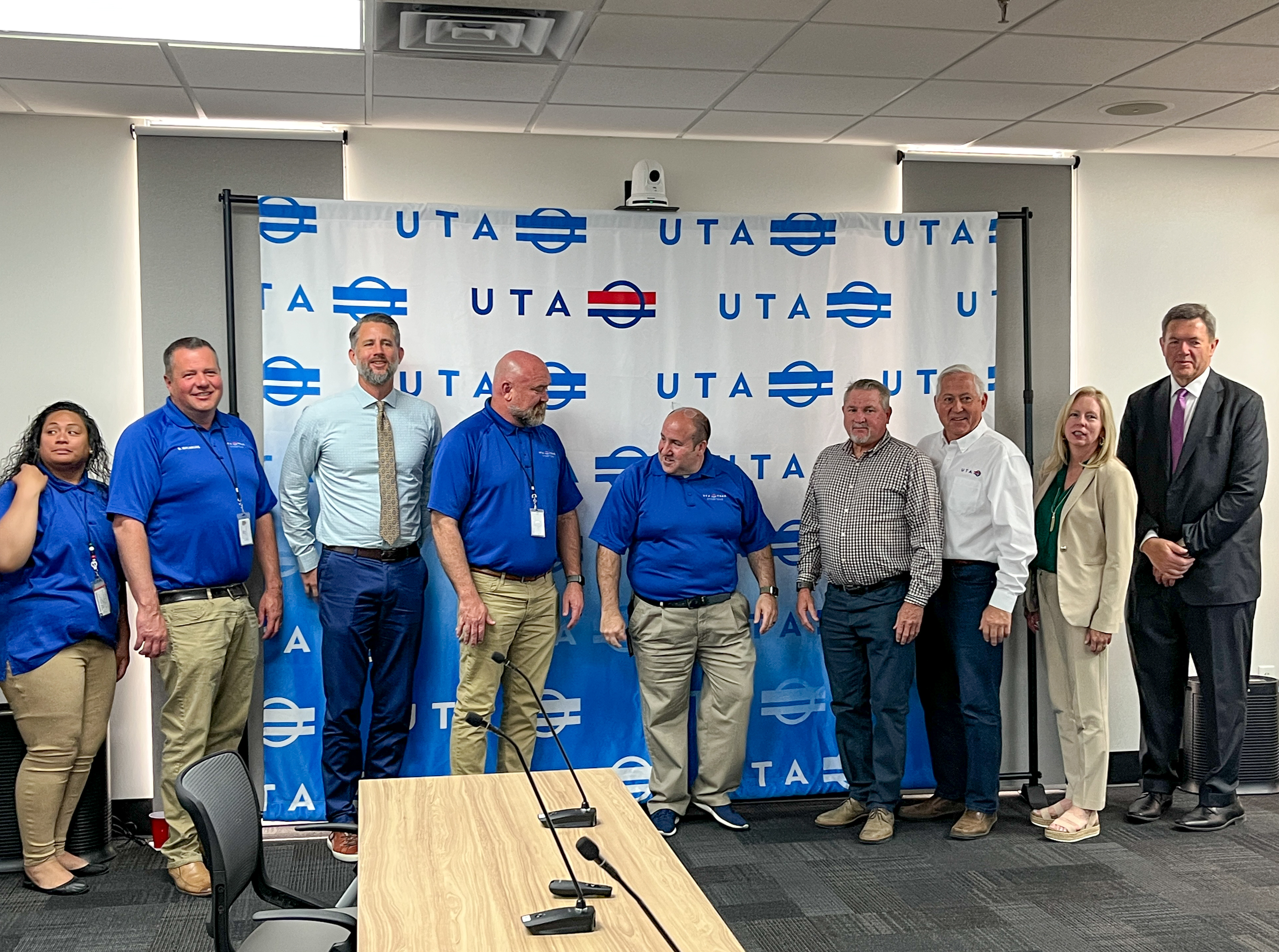 Chris Charlesworth, a TRAX supervisor, fourth from the right, gets a photo with Utah Transit Authority employees Wednesday. Charlesworth helped a man who threatened to jump from a parking structure on April 29.
