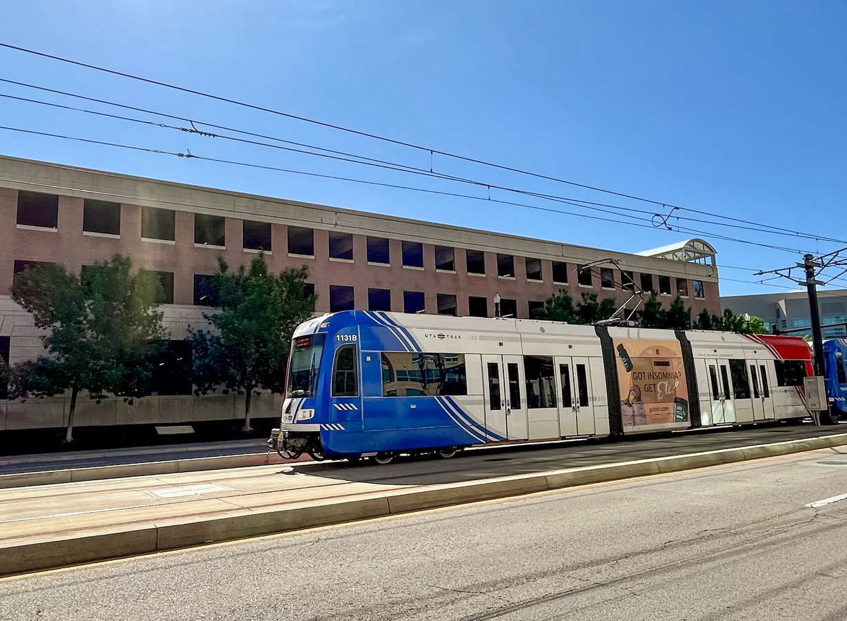 A green line TRAX train passes the Triad Center parking garage Wednesday morning.