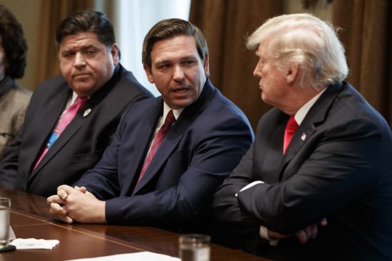 Gov.-elect Ron DeSantis, R-Fla., talks with President Donald Trump during a meeting with newly elected governors in the Cabinet Room of the White House, Dec. 13, 2018, in Washington. From left, Governor-elect J.B. Pritzker, D-Ill., DeSantis, and Trump.