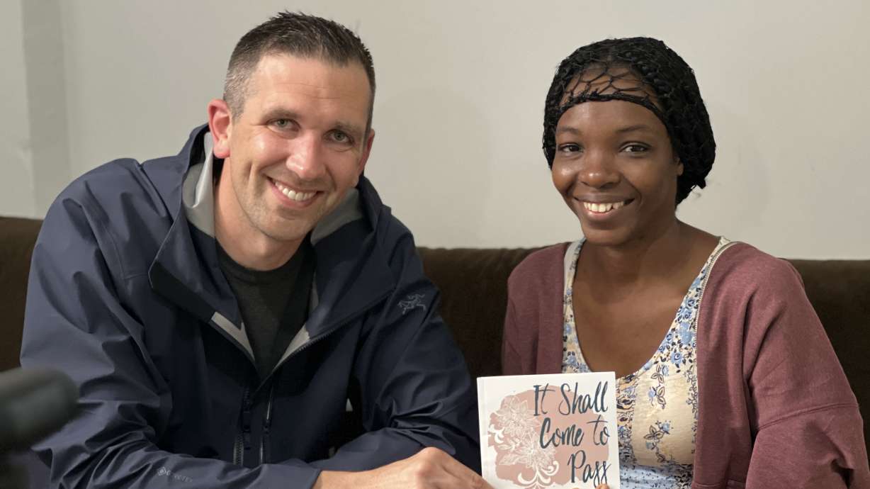 Ben Taylor, of Ogden, and Chickaordery Vivian Ukabi hold her published book, "It Shall Come to Pass" in Istanbul on May 8, a few weeks before her life-changing surgery.