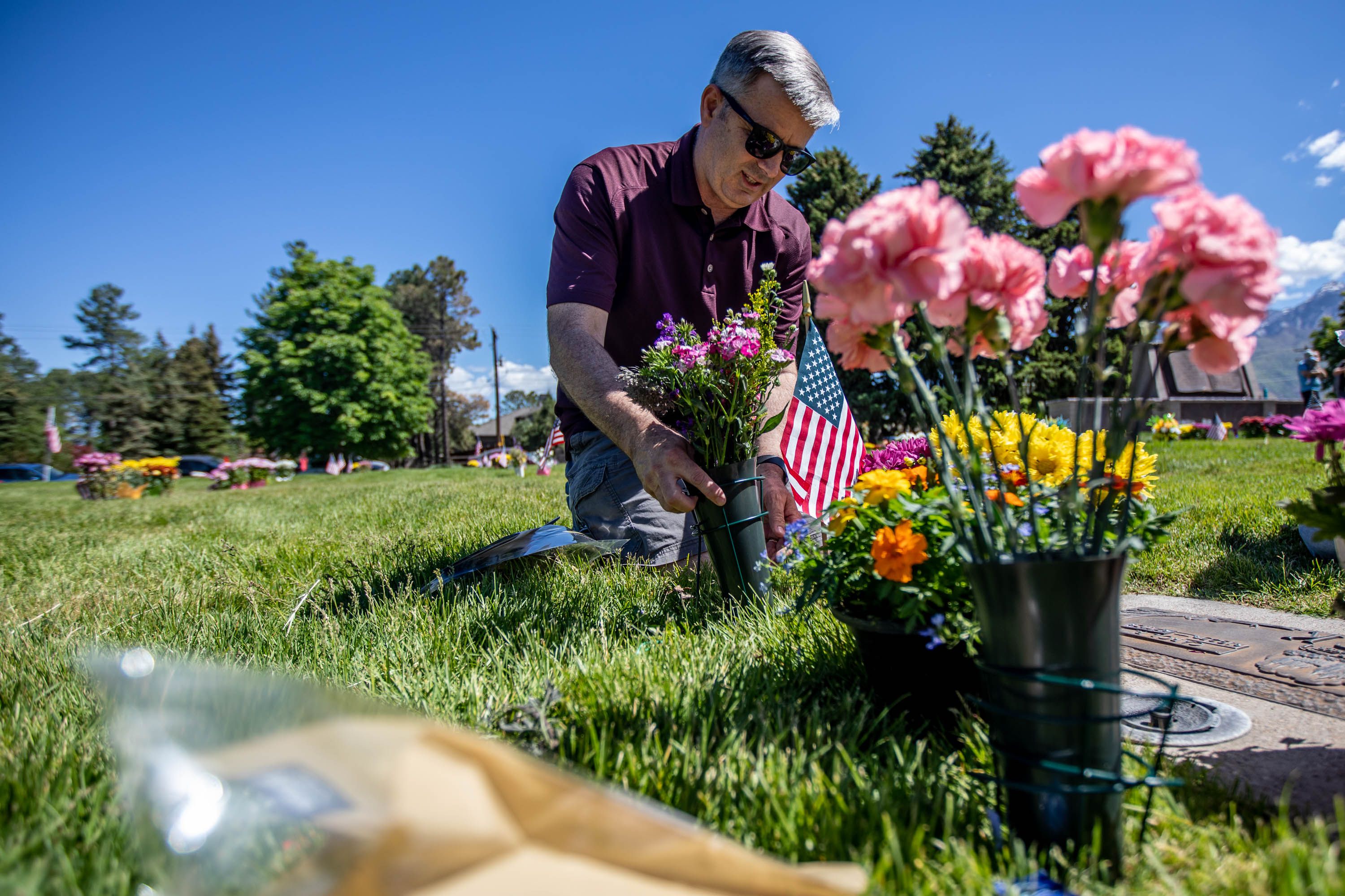 Allen Back visits his parents’ and aunt’s grave at Larkin Sunset Gardens Cemetery in Sandy on Monday, May 31, 2021.