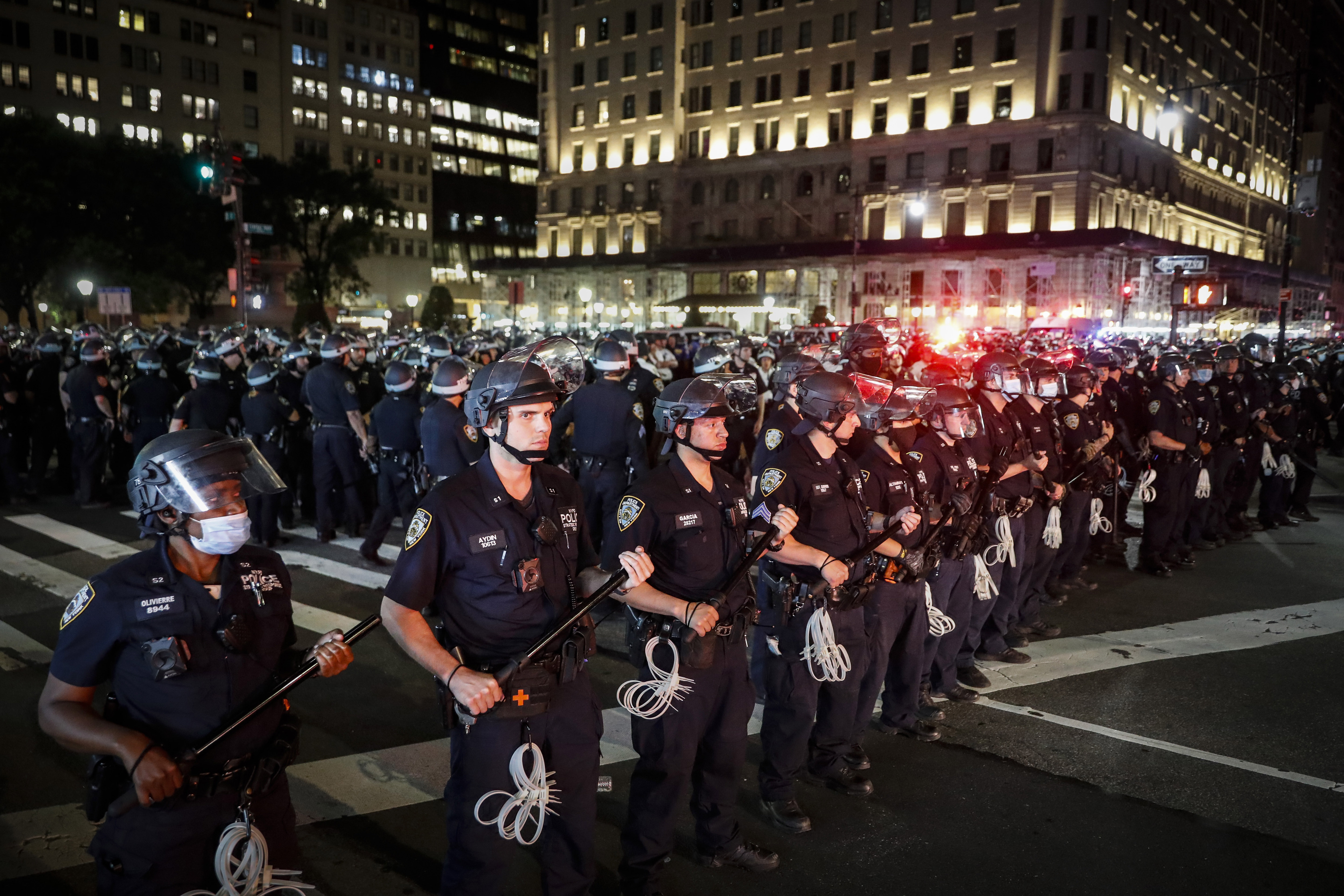 New York City Police Department officers stand in formation after arresting multiple protesters marching after curfew on Fifth Avenue on June 4, 2020, in New York, following the death of George Floyd. The third anniversary of Floyd’s murder is Thursday.