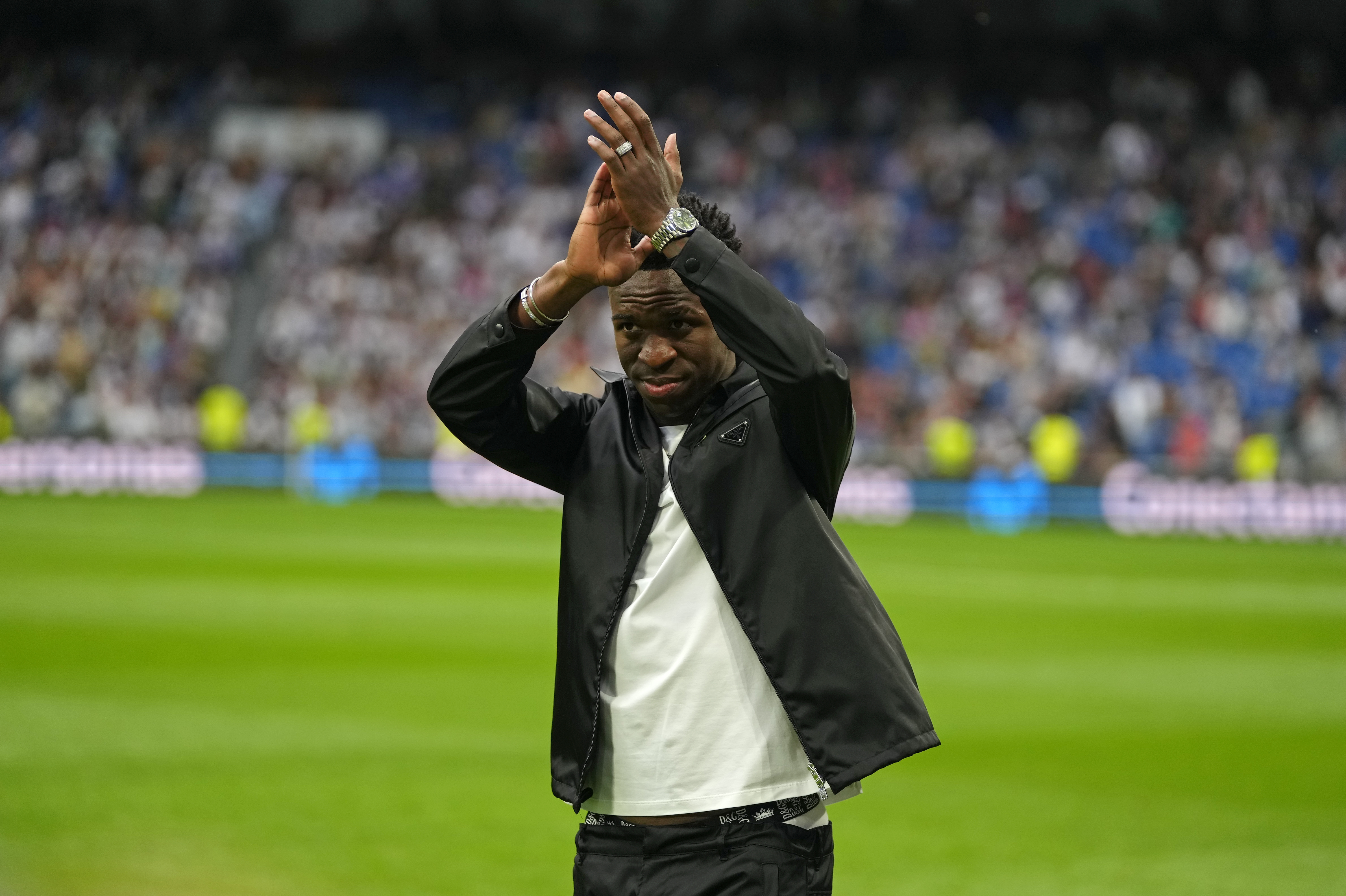 Real Madrid's Vinicius Junior applauds to spectators prior to a Spanish La Liga soccer match between Real Madrid and Rayo Vallecano at the Santiago Bernabeu stadium in Madrid, Spain, Wednesday, May 24, 2023.