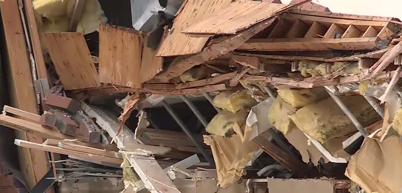 Debris is seen where a  building partially collapsed near 4890 S. Highland Drive Thursday afternoon.