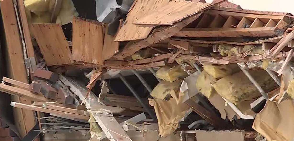 Debris is seen where a building partially collapsed near 4890 S. Highland Drive Thursday afternoon.