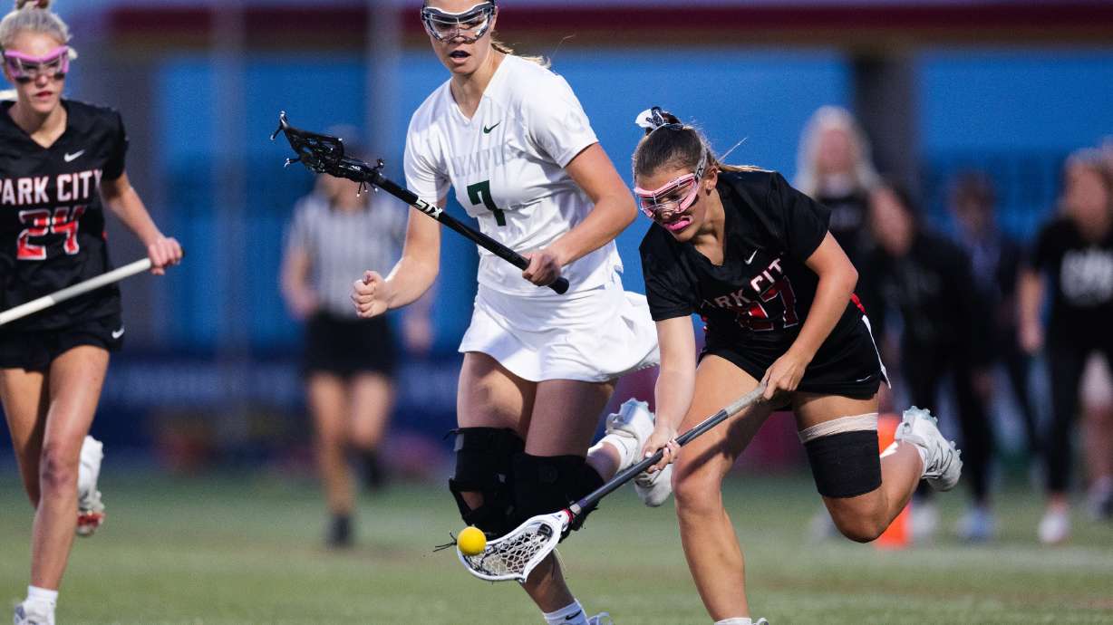 Park City’s Olivia Dalton (27) battles Olympus’ Hallie Christensen (7) during the 5A girls lacrosse championship at Zions Bank Stadium in Herriman on May 25, 2023.