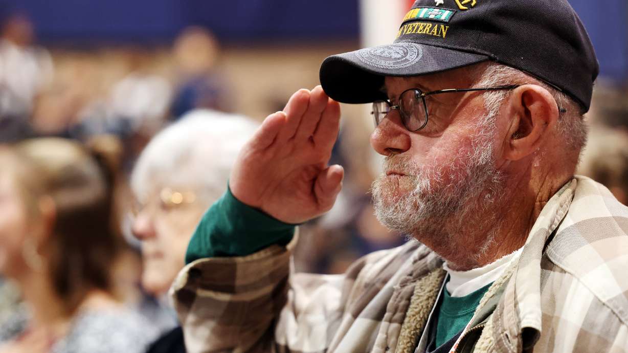 Veteran Michael West salutes during the posting of the colors at American Preparatory Academy in West Valley City on Nov. 8, 2021. More than $700,000 in unclaimed property has been returned to 750 Utah veterans so far.