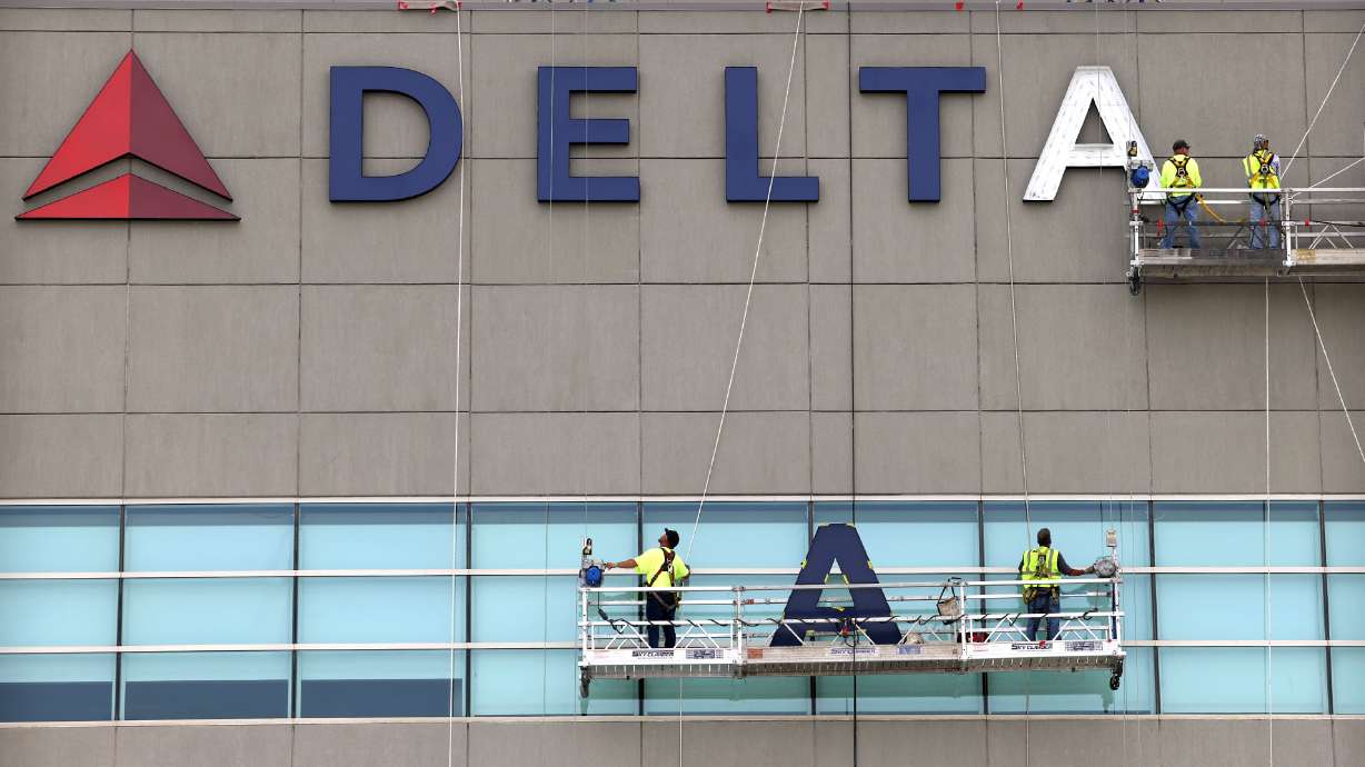 Exterior signage for the Delta Center is installed in Salt Lake City on Thursday. The arena was built in 1991 under the name Delta Center and will soon be called the Delta Center again.