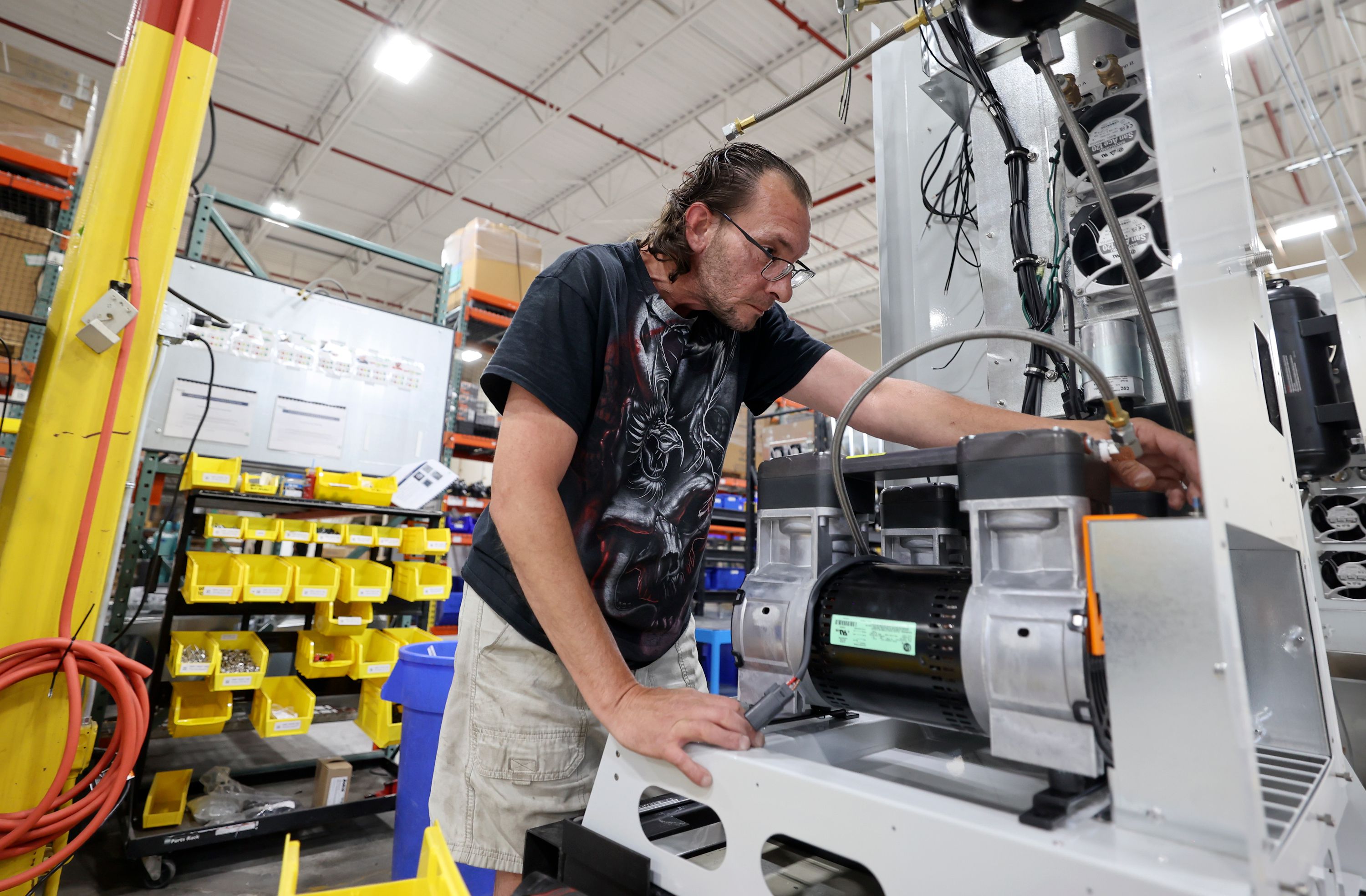 Qnergy production associate Mike Chesak works at Qnergy in Ogden on Thursday. Qnergy's Free Piston Stirling Engine is turning methane into electricity.