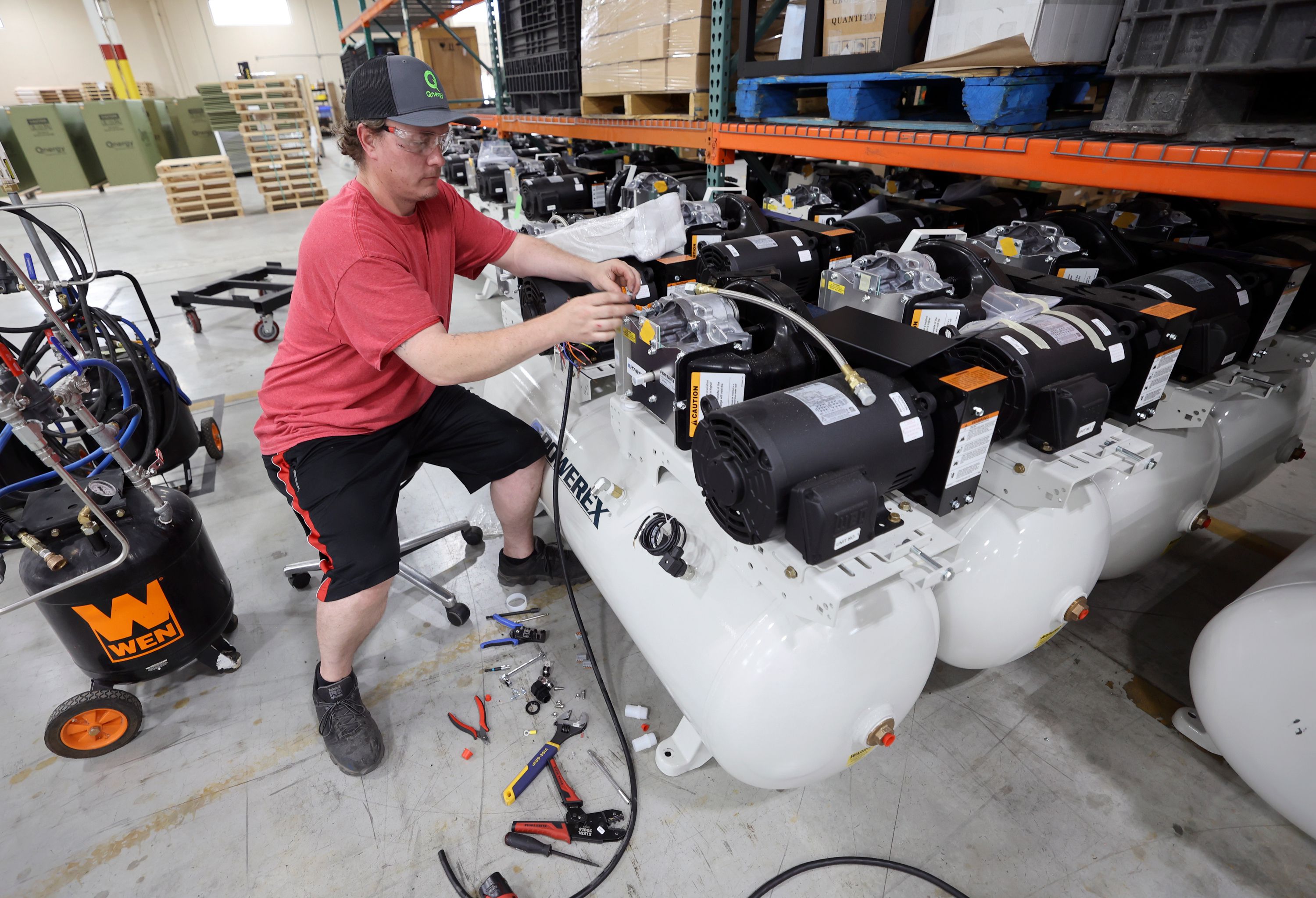 Qnergy production associate Adam Wright wires compressors on a Powerex tank at Qnergy in Ogden on Thursday.