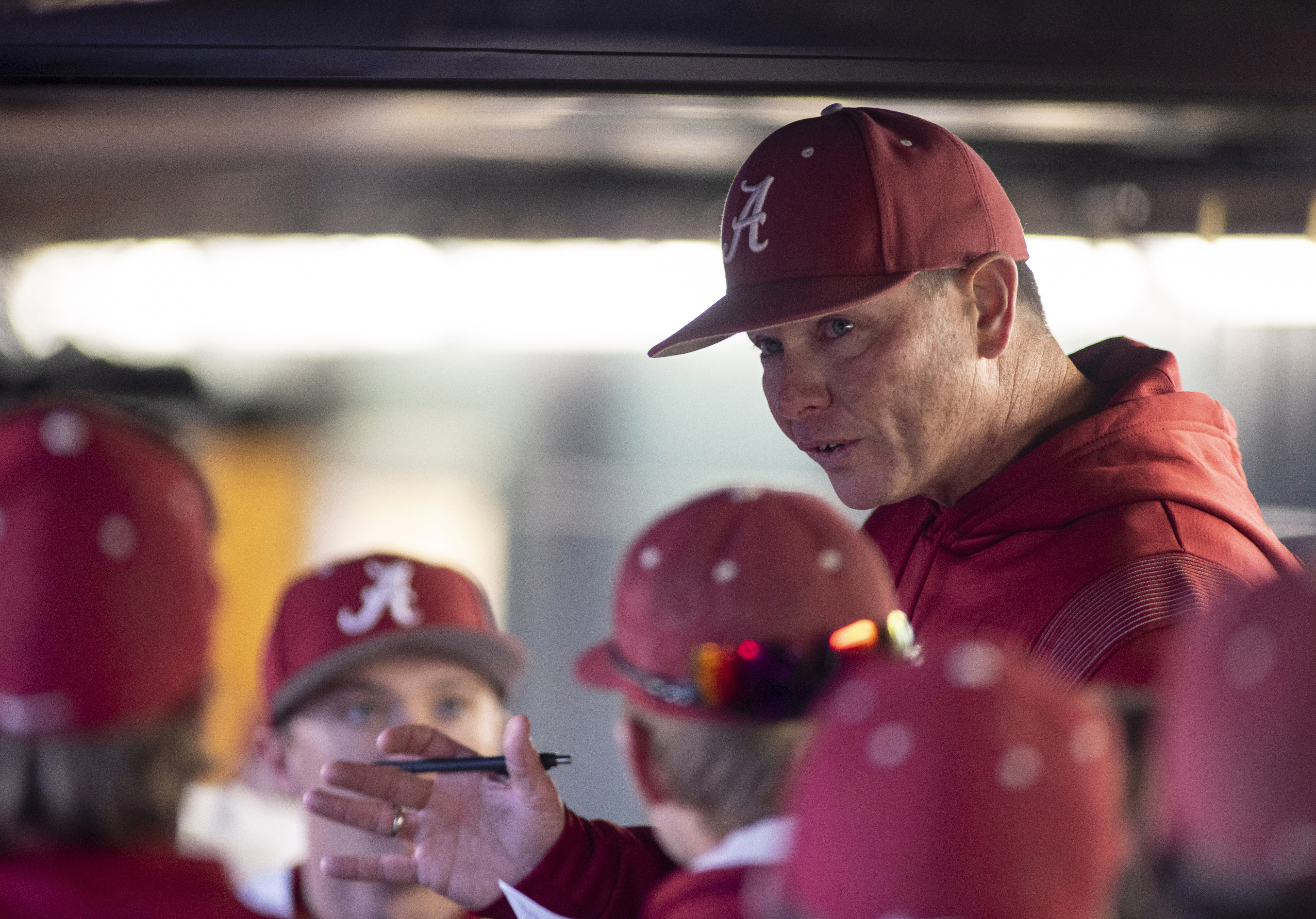 FILE - Alabama coach Brad Bohannon talks with the team in the dugout after Alabama rallied in the bottom of the ninth for a 5-4 win over Xavier in an NCAA college baseball game Feb. 18, 2022, in Tuscaloosa, Ala. An Indiana man whose son is a member of the University of Cincinnati baseball team is the bettor at the center of separate investigations that led to firings of Bohannon and two members of the Cincinnati baseball staff this month, two people familiar with the inquiries told The Associated Press on Friday, May 26.