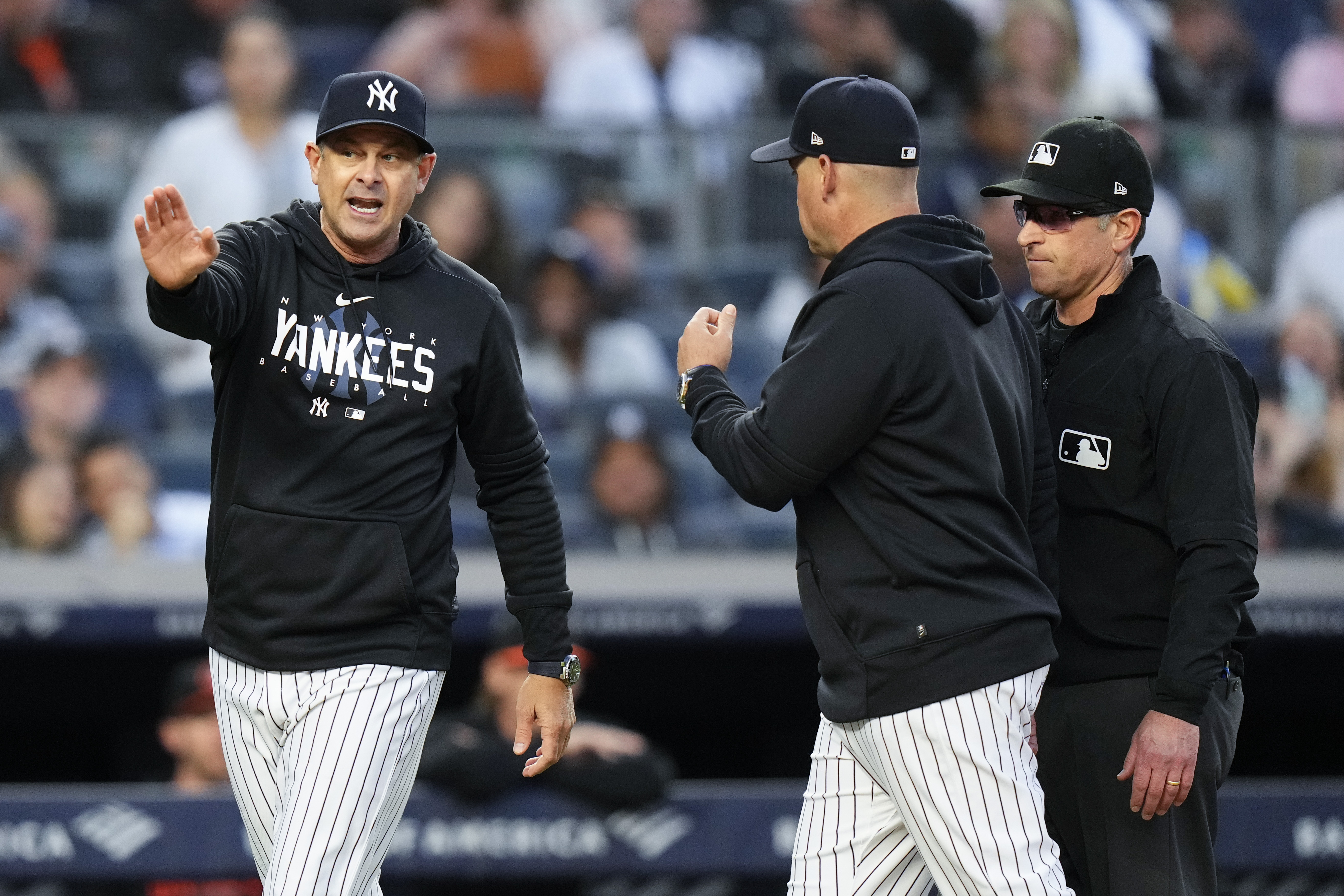 New York Yankees manager Aaron Boone, left, argues with umpire Chris Guccione, right, after Boone was ejected during the third inning of the team's baseball game against the Baltimore Orioles on Thursday, May 25, 2023, in New York. 