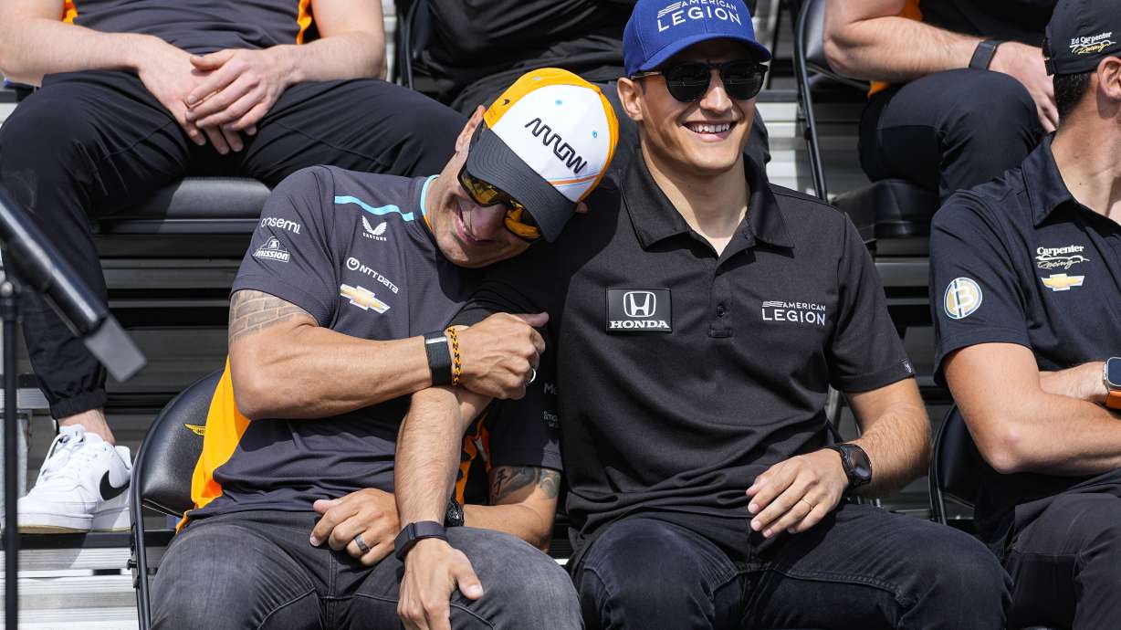 Tony Kanaan, of Brazil, left, jokes with Alex Palou, of Spain, during the drivers meeting for the Indianapolis 500 auto race at Indianapolis Motor Speedway in Indianapolis, Saturday, May 27, 2023.
