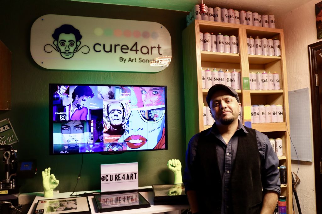 Mural artist Art Sanchez takes a photo in his art studio in St. George on May 8.