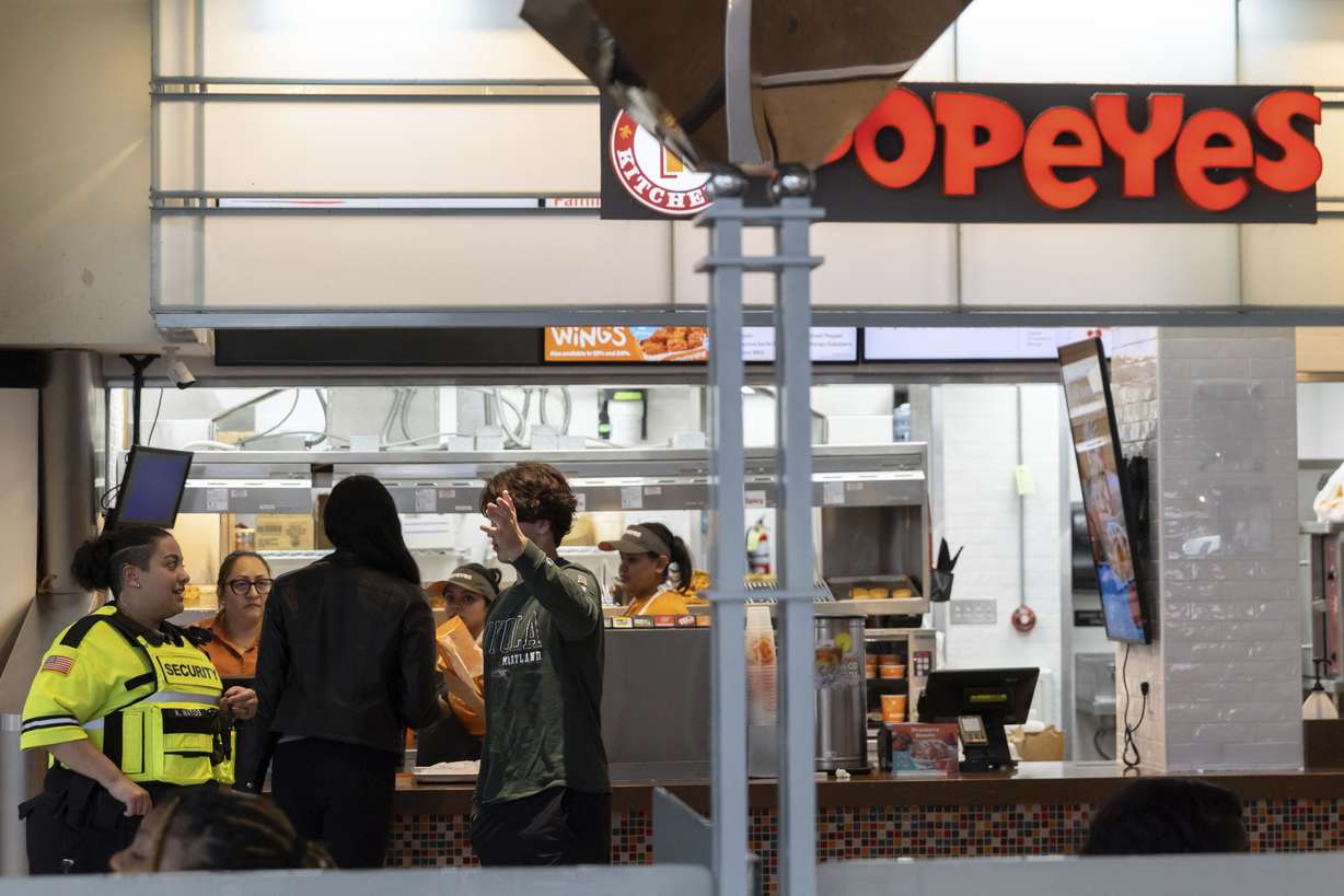 A security guard asks a teen to leave the Mall in Columbia May 12, 2023, in Columbia, Md. The mall has implemented a "Parental Guidance Required" program, which requires that all visitors under 18 be accompanied by an adult who is at least 21-years-old after 4 p.m. on Fridays and Saturdays.