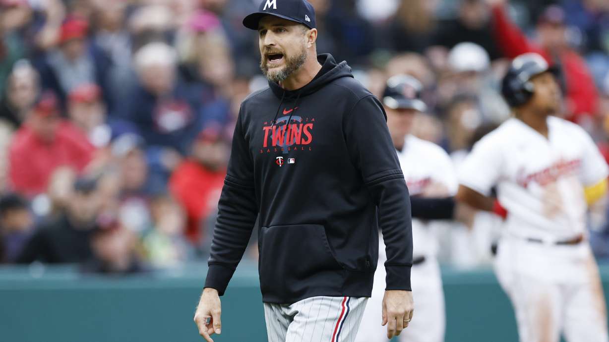 Minnesota Twins manager Rocco Baldelli walks off the field after being ejected for arguing a call during the fourth inning of a baseball game against the Cleveland Guardians, Saturday, May 6, 2023, in Cleveland.
