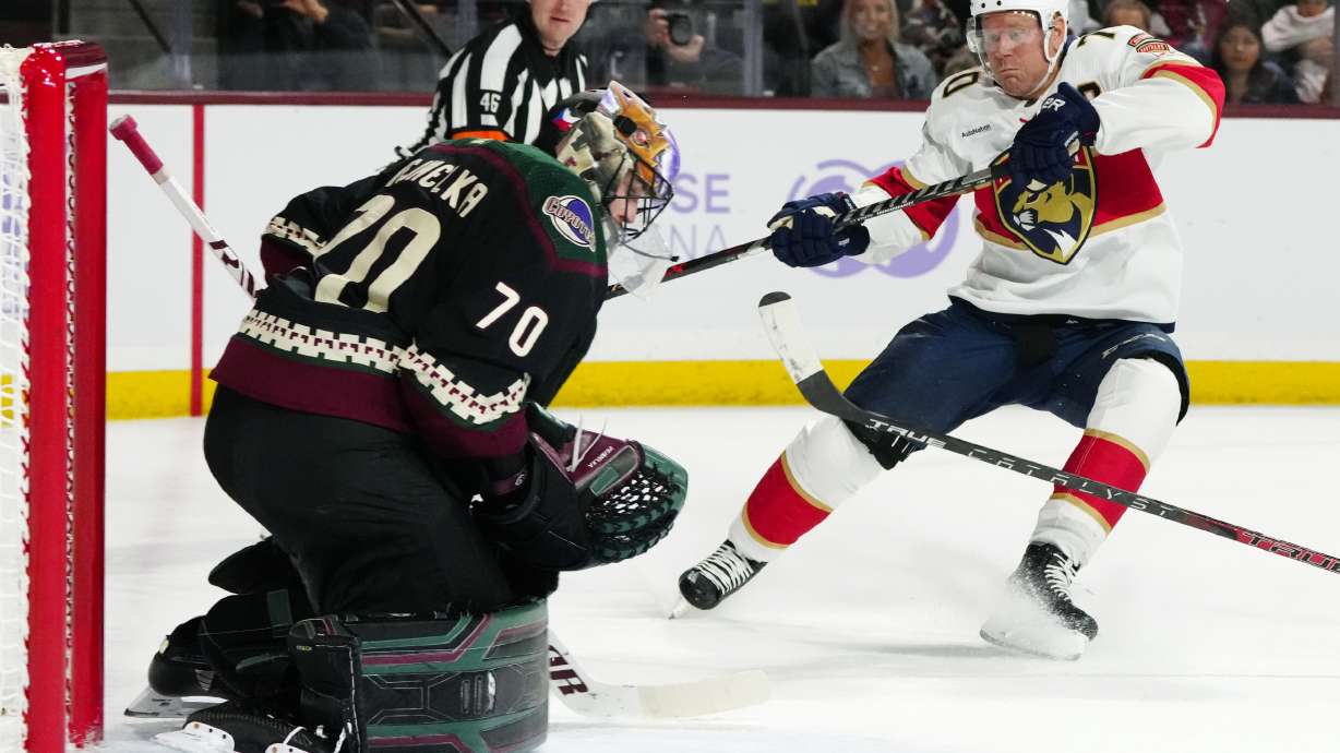 FILE - Arizona Coyotes goaltender Karel Vejmelka (70) makes a save on a shot by Florida Panthers right wing Patric Hornqvist, right, during the second period of an NHL hockey game in Tempe, Ariz., Nov. 1, 2022. Hornqvist will not play in the Stanley Cup Final for the Florida Panthers because of a December concussion, but the team insists he is still a big part of their success.