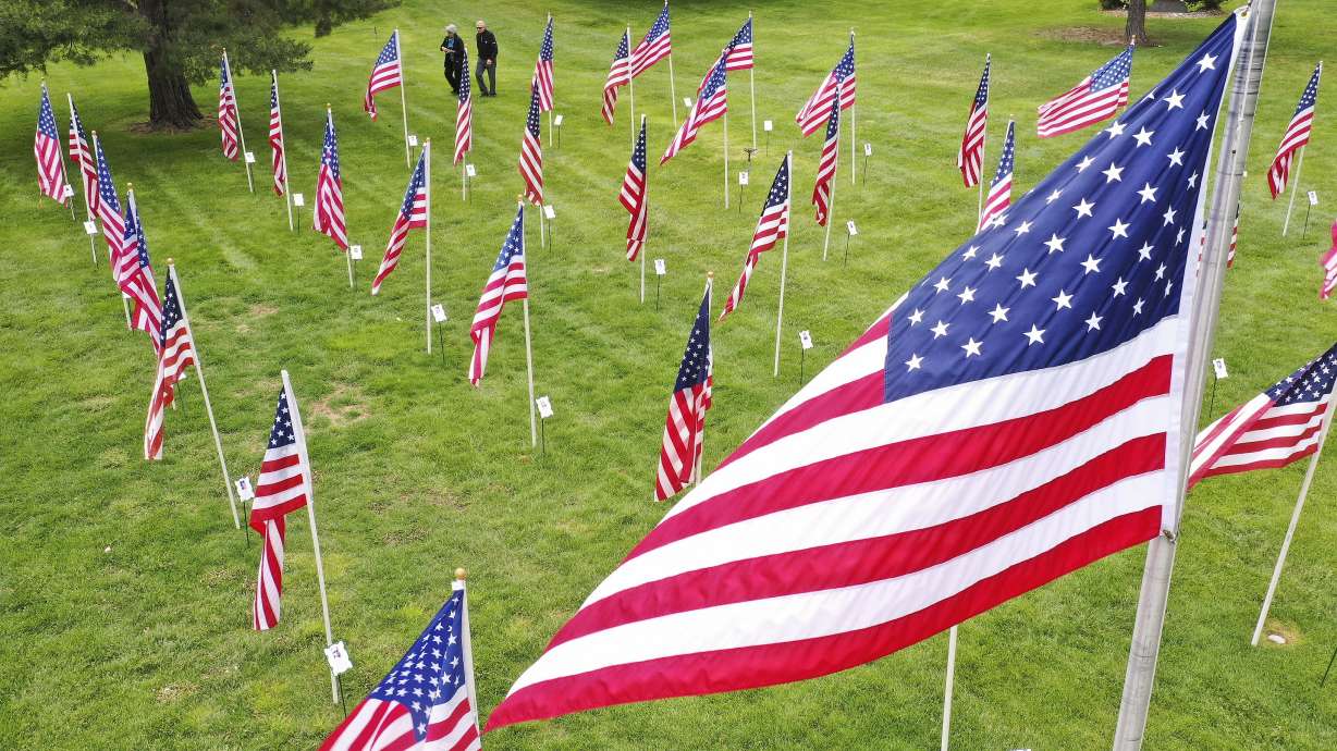 A couple walks through the Flags of Honor at Memorial Mountain View Cemetery in Cottonwood Heights on May 24, 2020. The flags honor soldiers who have died since 9-11.