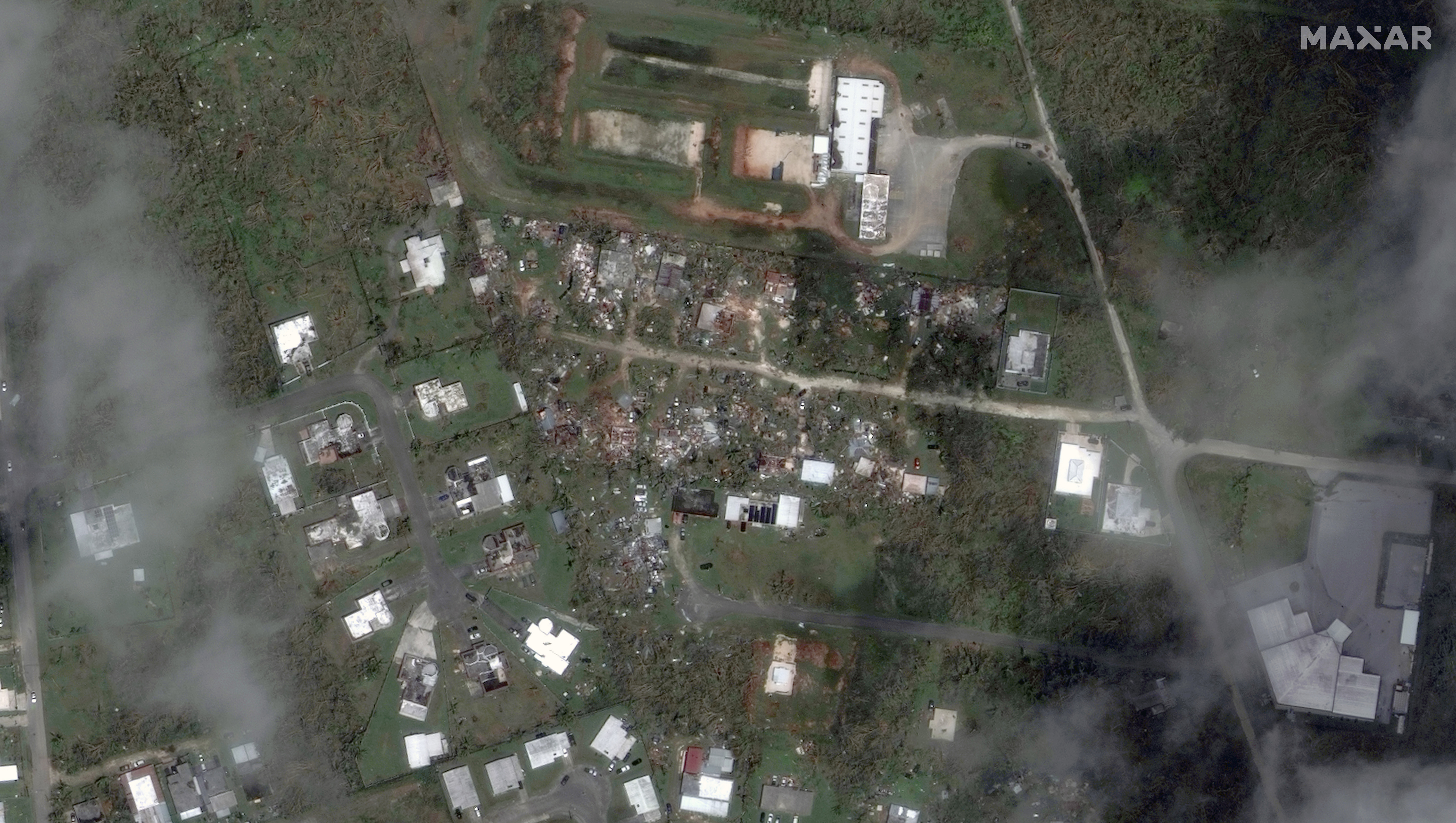 This satellite image provided by Maxar Technologies shows a damaged area in Dededo, Guam, Friday, after Typhoon Mawar tore through the remote U.S. Pacific territory.