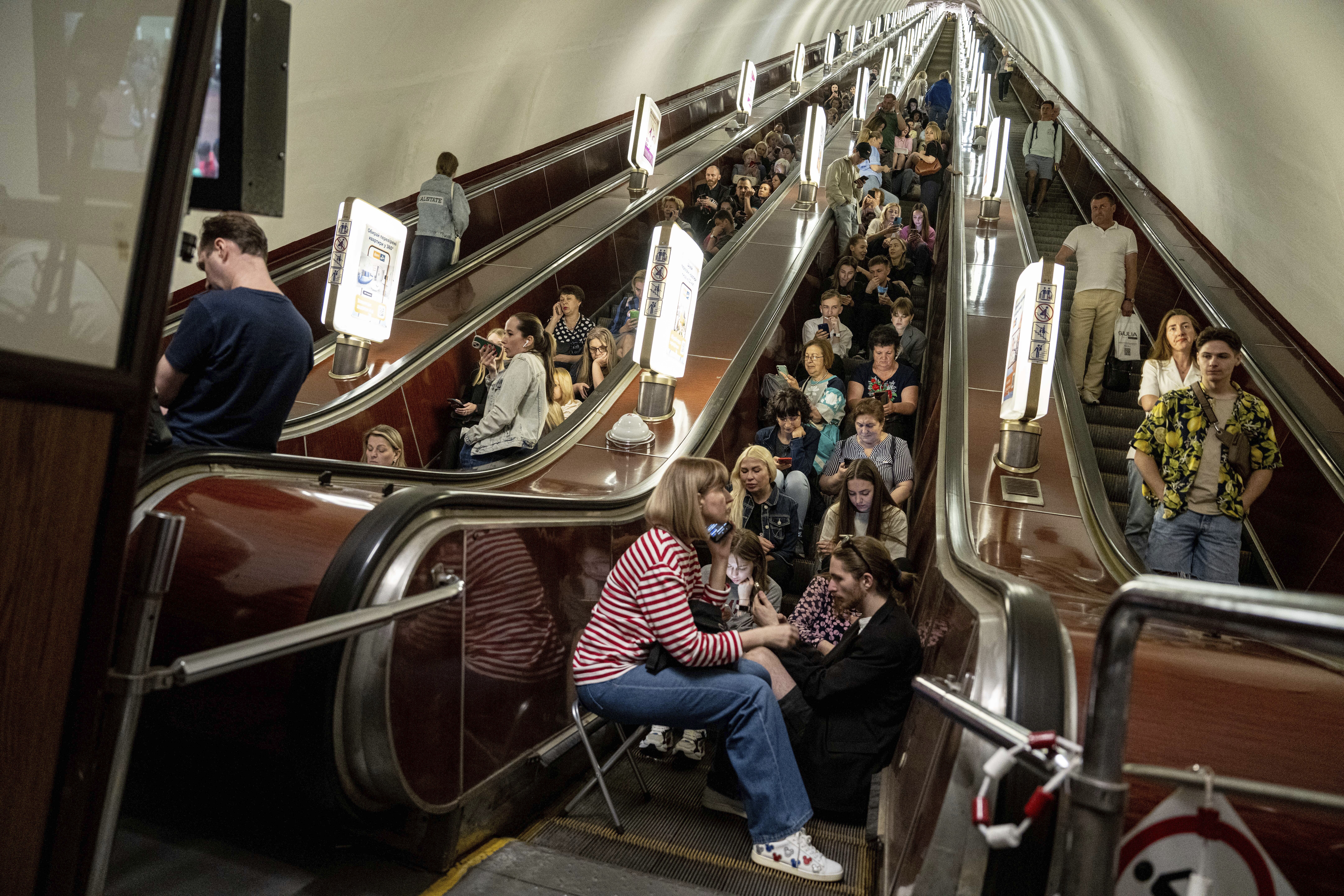 People take cover at metro station during a Russian rocket attack in Kyiv, Ukraine, Monday. Explosions have rattled Kyiv during daylight as Russian ballistic missiles fell on the Ukrainian capital.