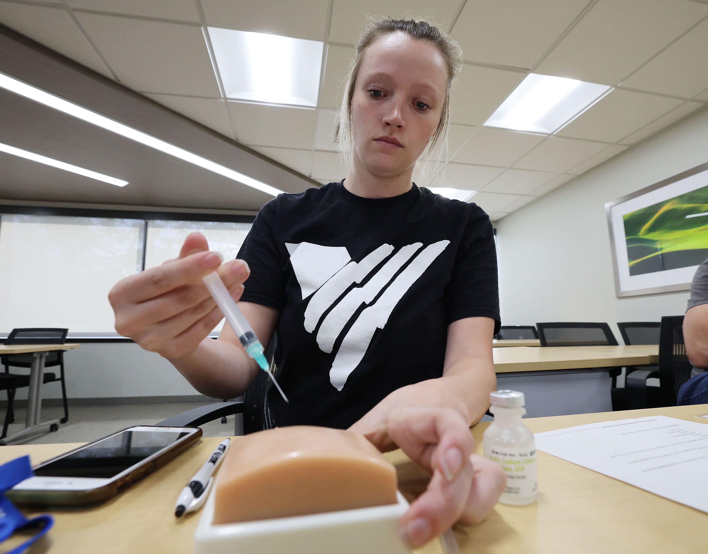 Ashland Davis, With Volunteers of America, practices a naloxone injection during Utah Naloxone training for opioid overdose in Salt Lake City on May 23.
