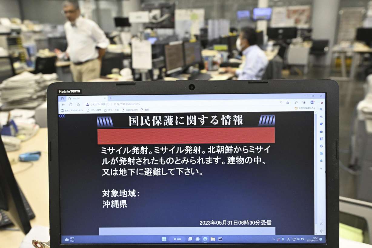 A monitor in Tokyo shows J-Alert or National Early Warning System to the residents in Okinawa, southern Japan, Wednesday. The screen reads " Missile launched. Seems missile was launched from North Korea. Please take shelter inside buildings or underground. "