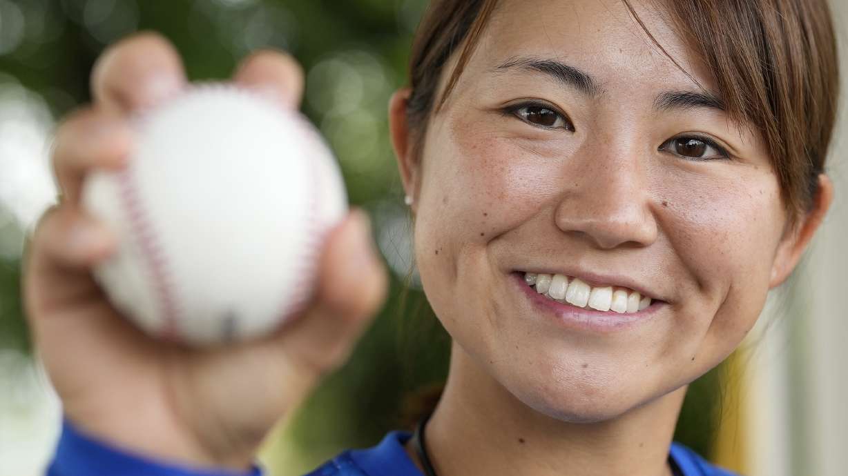 Eri Yoshida of a Japanese women's baseball team, Agekke, shows her knuckleball grip during an interview in Oyama, Tochigi prefecture, north of Tokyo, Tuesday, May 30, 2023. The 31-year-old Japanese woman is a knuckleball pitcher with a sidearm delivery that she hopes might carry her to the big leagues in the United States or Japan.