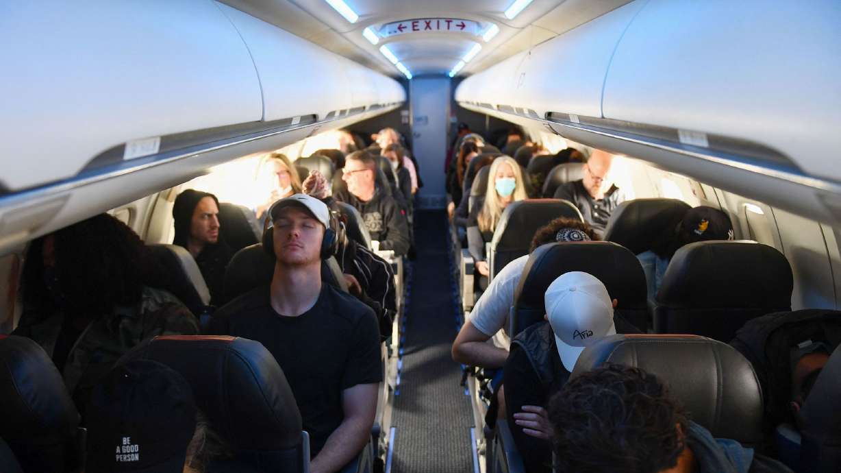 Passengers sit during an American Airlines flight from Los Angeles International Airport to Denver, Colorado, on April 19, 2022. Two Senate Democrats want the Biden administration to take another look at whether airplane seats are too cramped.
